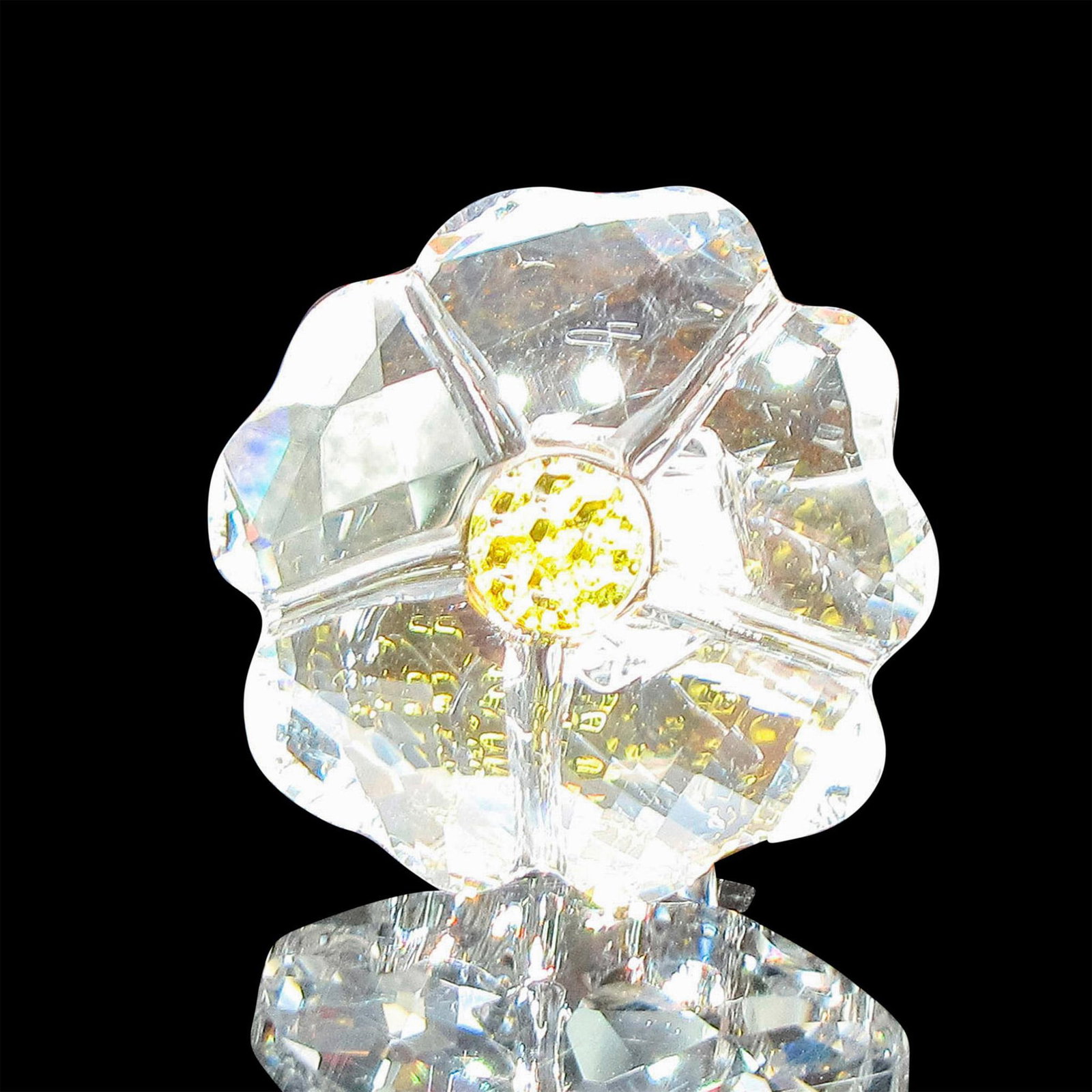 Swarovski Silver Crystal Figurine, Member Wild Flower: Faceted clear crystal with yellow crystal center and clear stem. Swarovski backstamp. This item has its original box: 2.5"H x 3.25"dia. Issued: 20th century Dimensions: 1"L x 1.75"W x 1"H Manufacturer