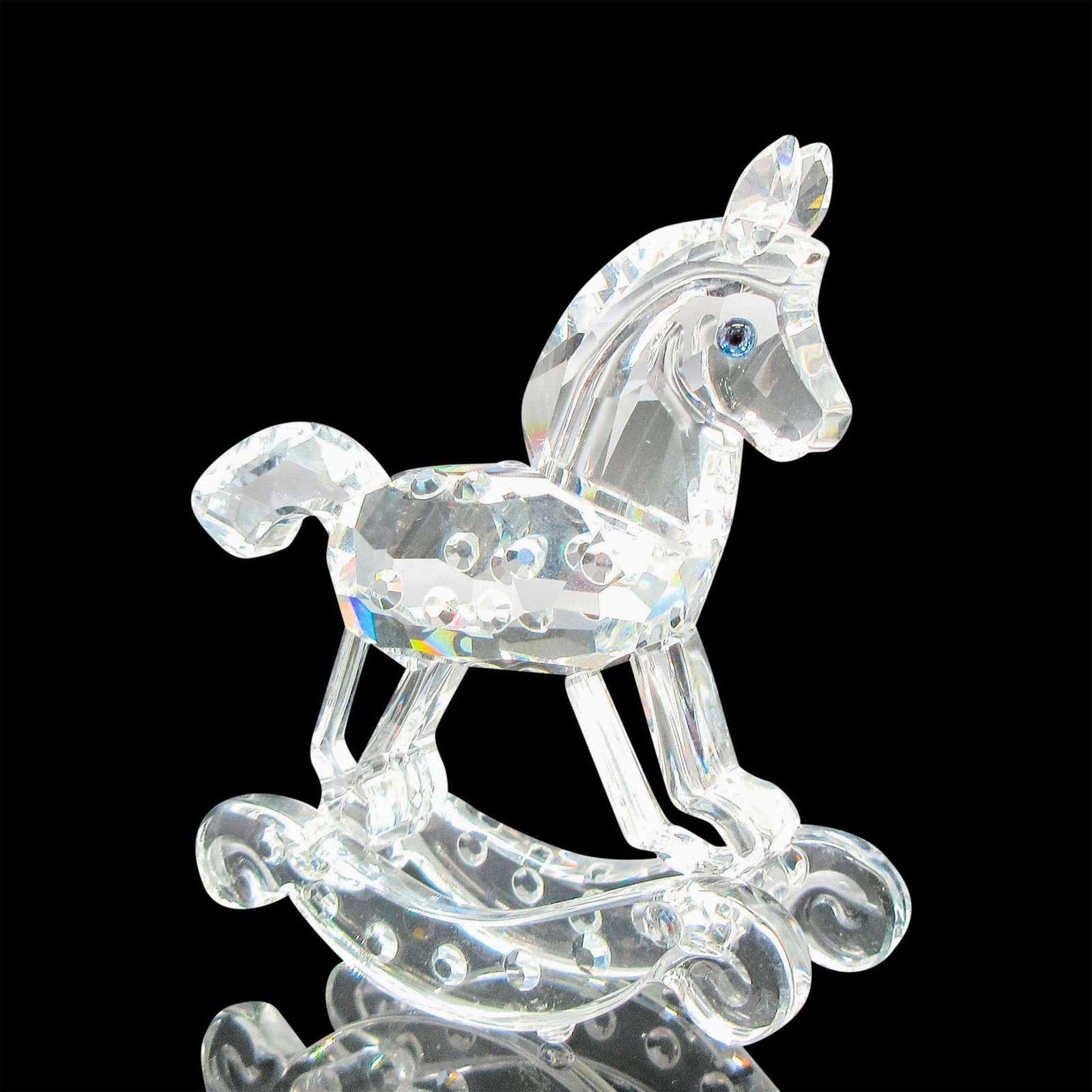 Swarovski Crystal Figurine, Rocking Horse: Part of the When We Were Young collection. Clear faceted detailed figural with blue crystal eyes. Swarovski backstamp. Artist: Gabriele Stamey Issued: 20th century Dimensions: 2.75"L x 1"W x 2.75"H Ma