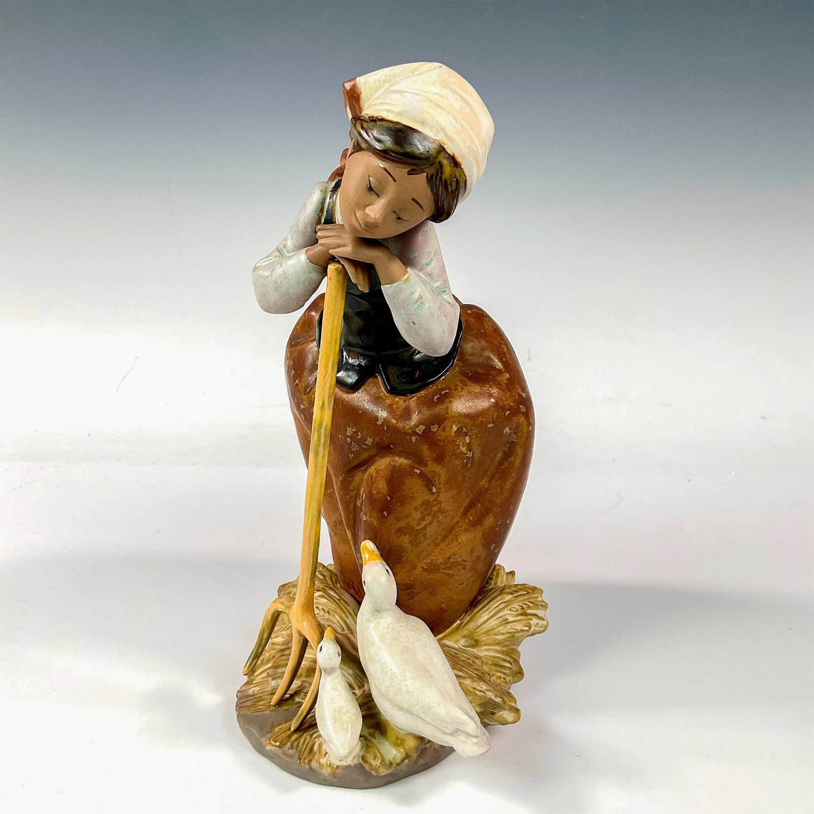 Sharing The Harvest 1012179 - Lladro Porcelain Figurine: Gres finish; Lladro backstamp. Artist: Jose Puche Issued: 1988 - 2001 Dimensions: 9.75"H x 6"W Manufacturer: Lladro Country of Origin: Spain