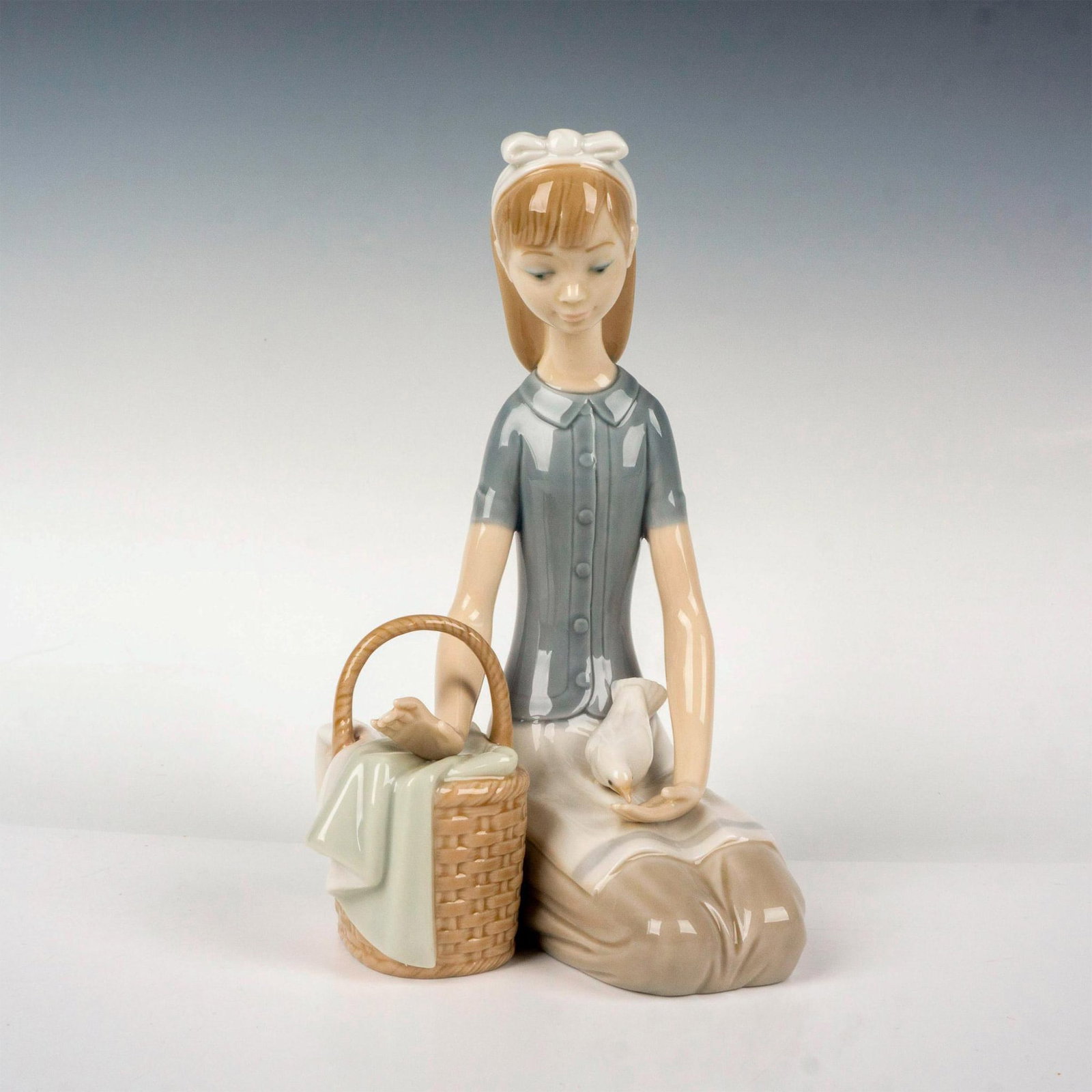 Girl With Dove 1004909 - Lladro Porcelain Figurine: Glossy finish; Lladro backstamp. Artist: Francisco Catala Issued: 1974 - 1982 Dimensions: 7.75"H Manufacturer: Lladro Country of Origin: Spain