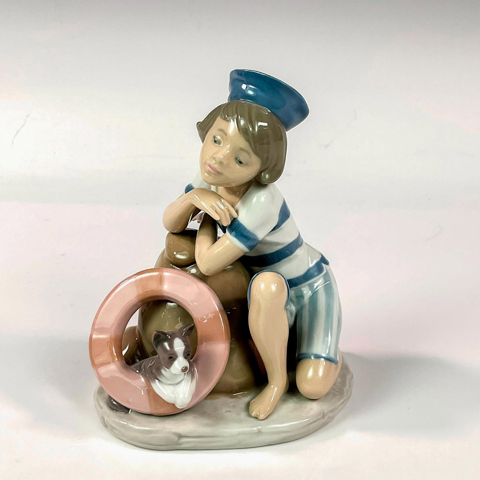 Monday's Child (Boy) 1006011 - Lladro Porcelain Figurine: Glossy finish; Lladro backstamp. Artist: Juan Huerta Issued: 1993 - 1997 Dimensions: 5.5"H Manufacturer: Lladro Country of Origin: Spain