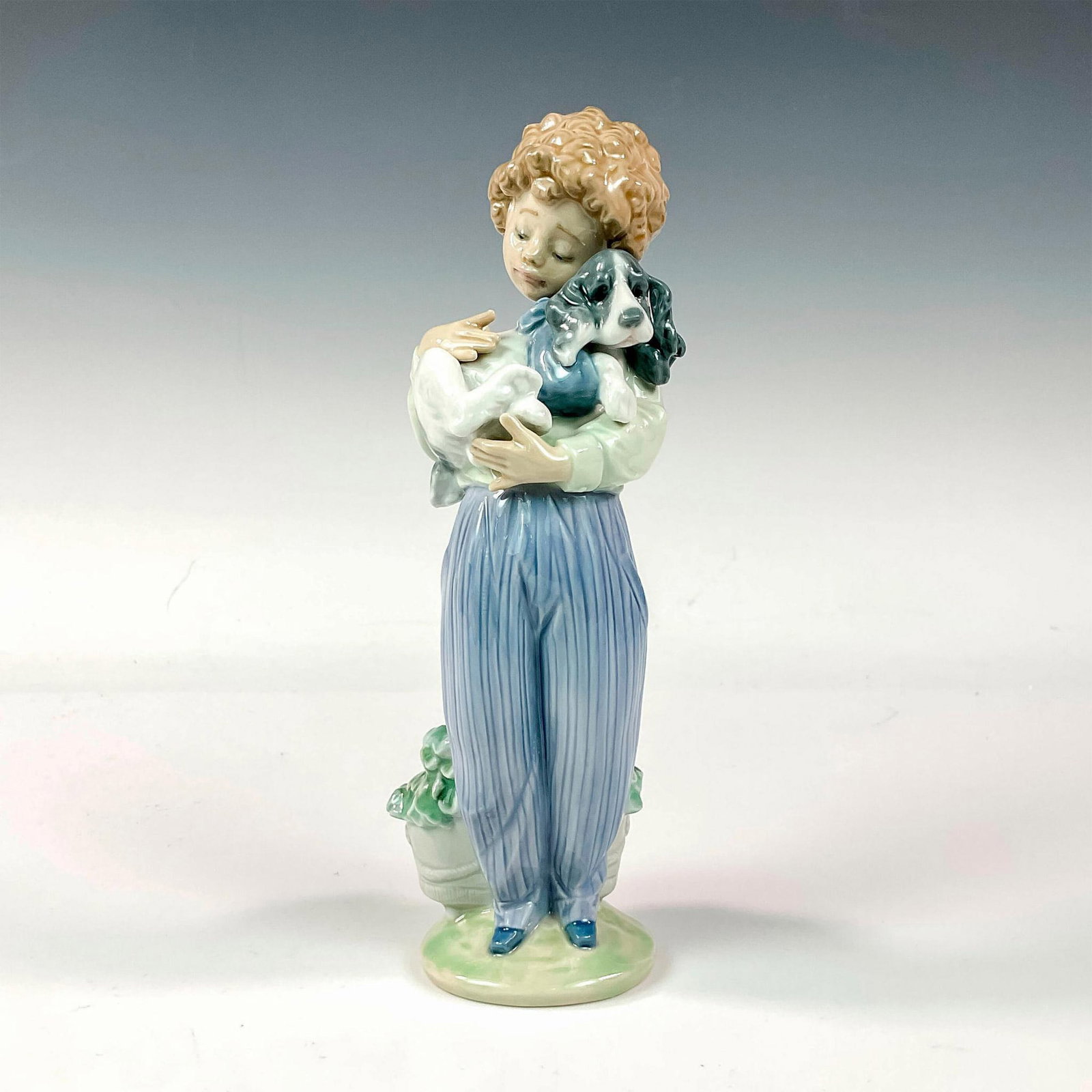 My Buddy 1007609 - Lladro Porcelain Figurine: Glossy finish; Lladro backstamp. Artist: Antonio Ramos Issued: 1989 - 1989 Dimensions: 8.75"H x 3.25"W Manufacturer: Lladro Country of Origin: Spain
