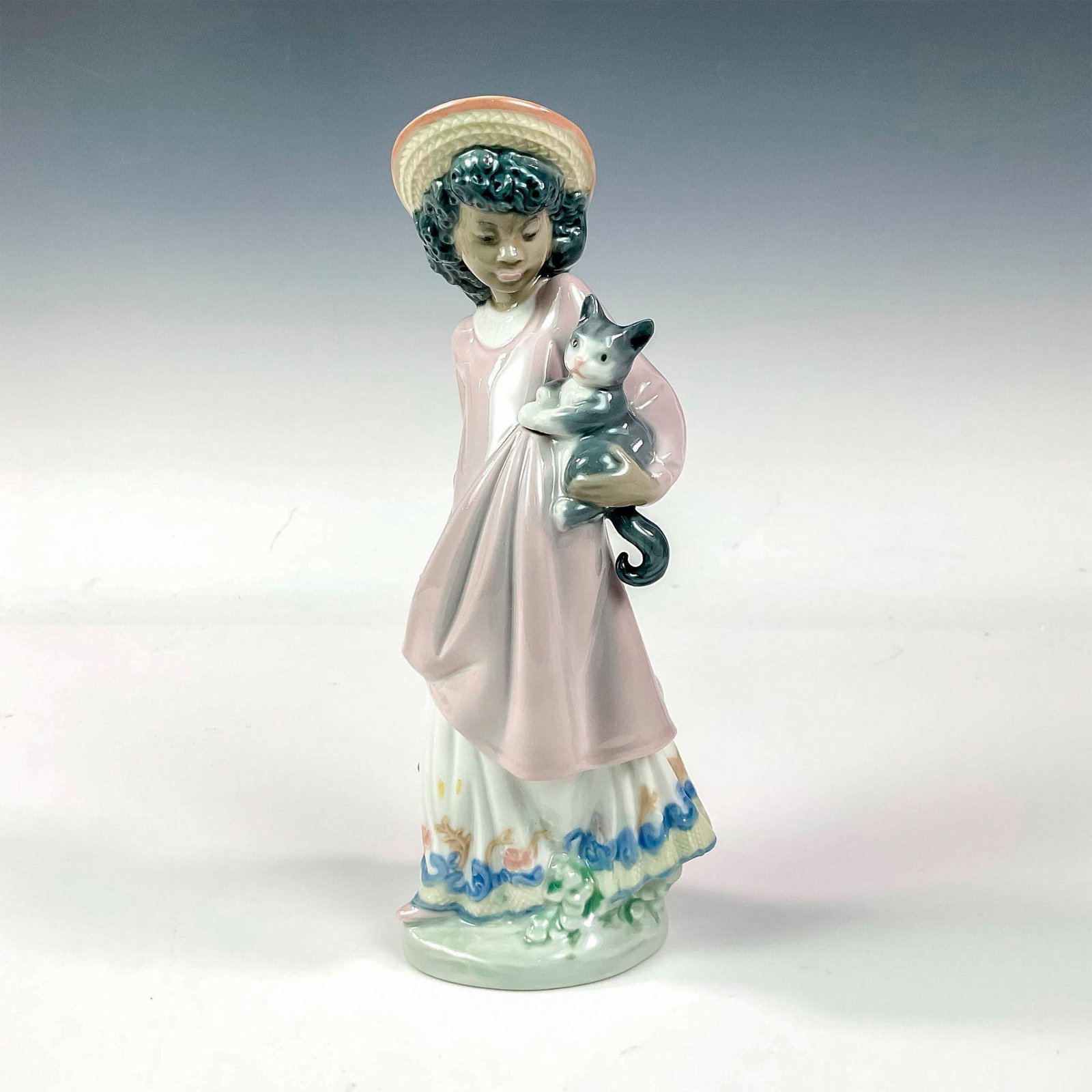 My New Pet 1005549 - Lladro Porcelain Figurine: Glossy finish; Lladro backstamp. Artist: Juan Huerta Issued: 1989 - 1998 Dimensions: 8.25"H x 4"W Manufacturer: Lladro Country of Origin: Spain