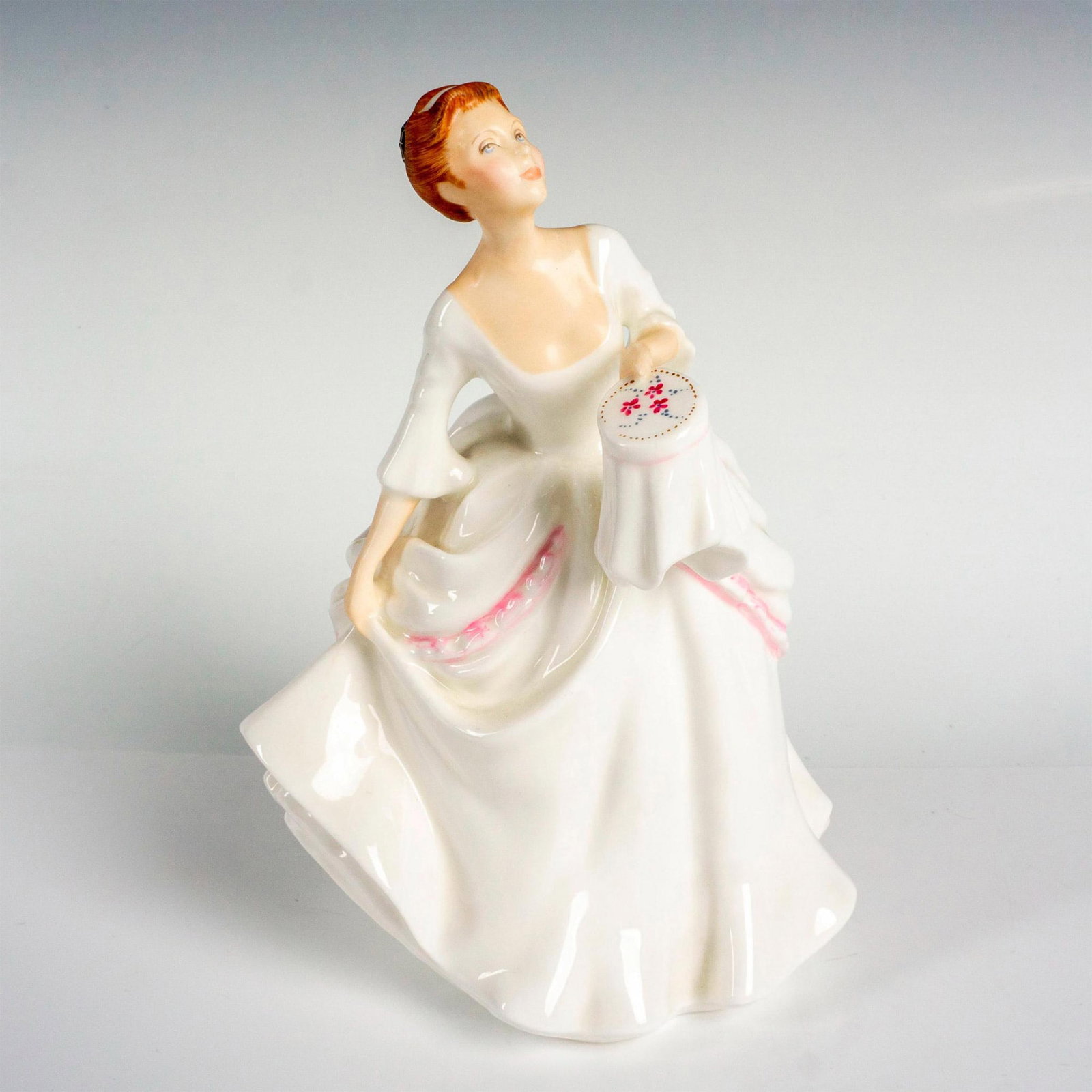 Carol - HN2961 - Royal Doulton Figurine: Vanity Fair Ladies series; lady holding an embroidery hoop. Royal Doulton backstamp. Artist: Pauline Parsons Issued: 1982 - 1995 Dimensions: 7.5"H Manufacturer: Royal Doulton Country of Origin: E