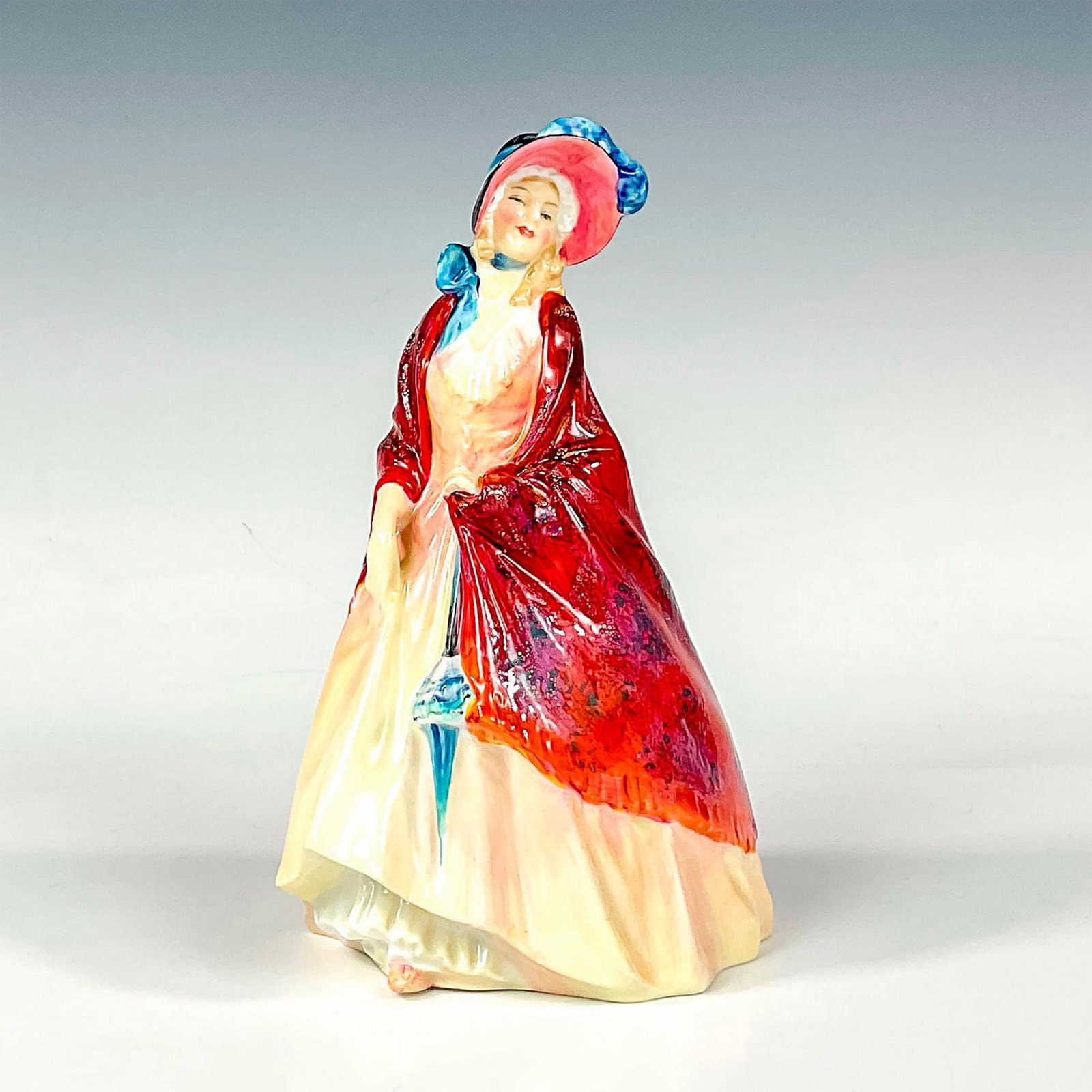 Paisley Shawl - HN1987 - Royal Doulton Figurine: Glaze finish; Royal Doulton backstamp. Artist: Leslie Harradine Issued: 1946 - 1959 Dimensions: 8.25"H Manufacturer: Royal Doulton Country of Origin: England