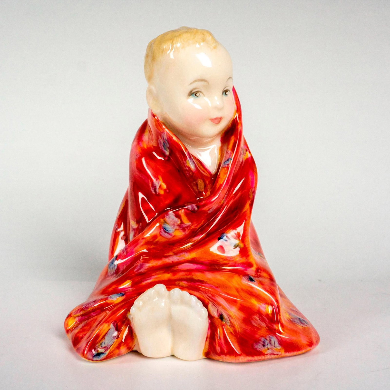 This Little Pig - HN1793 (red) - Royal Doulton Figurine: Child Classics series; young boy wrapped in a blanket. Royal Doulton backstamp. Artist: Leslie Harradine Issued: 1936 - 1995 Dimensions: 4"H Manufacturer: Royal Doulton Country of Origin: England