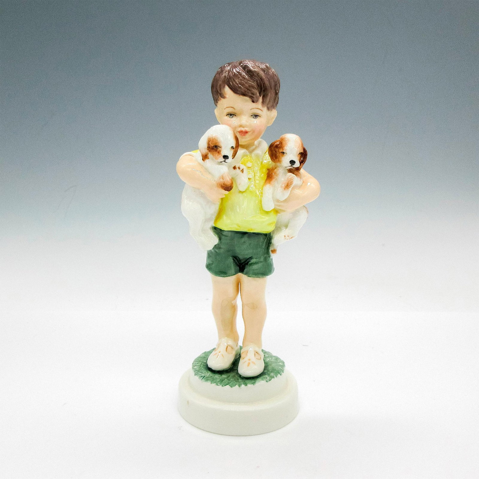 Royal Worcester Bone China Figurine, All Mine: Adorable glazed figural holding 2 puppies. Royal Worcester backstamp. 3519. Artist: F.G. Doughty Issued: 20th century Dimensions: 7.25"H x 2.5"dia. Manufacturer: Royal Worcester Country of Origin: