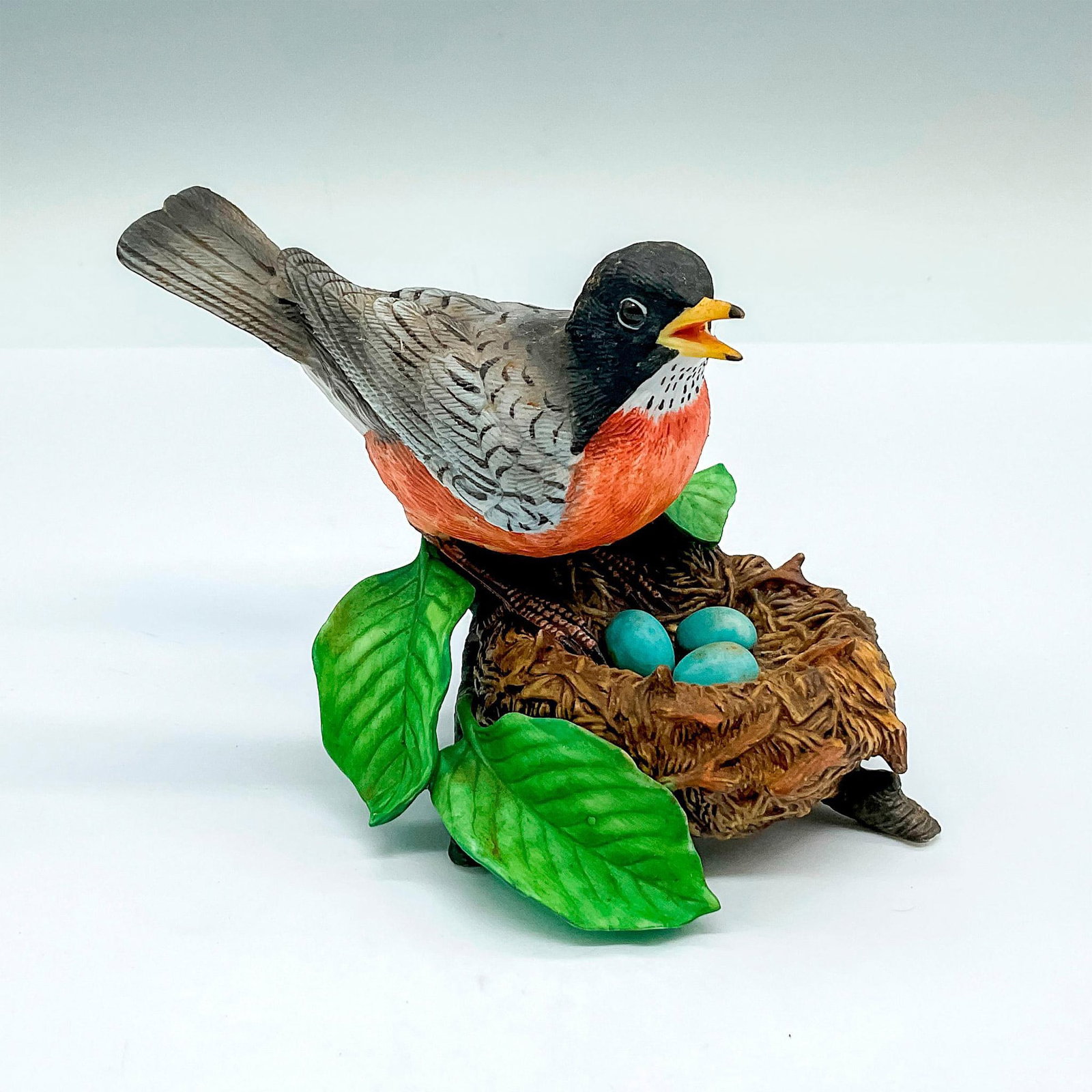 Lenox Fine Porcelain Figurine, American Robin: A charming matte figure of a robin over her blue eggs. Lenox backstamp. Issued: 1989 Dimensions: 5.5"L x 3.75"W x 3.5"H Manufacturer: Lenox