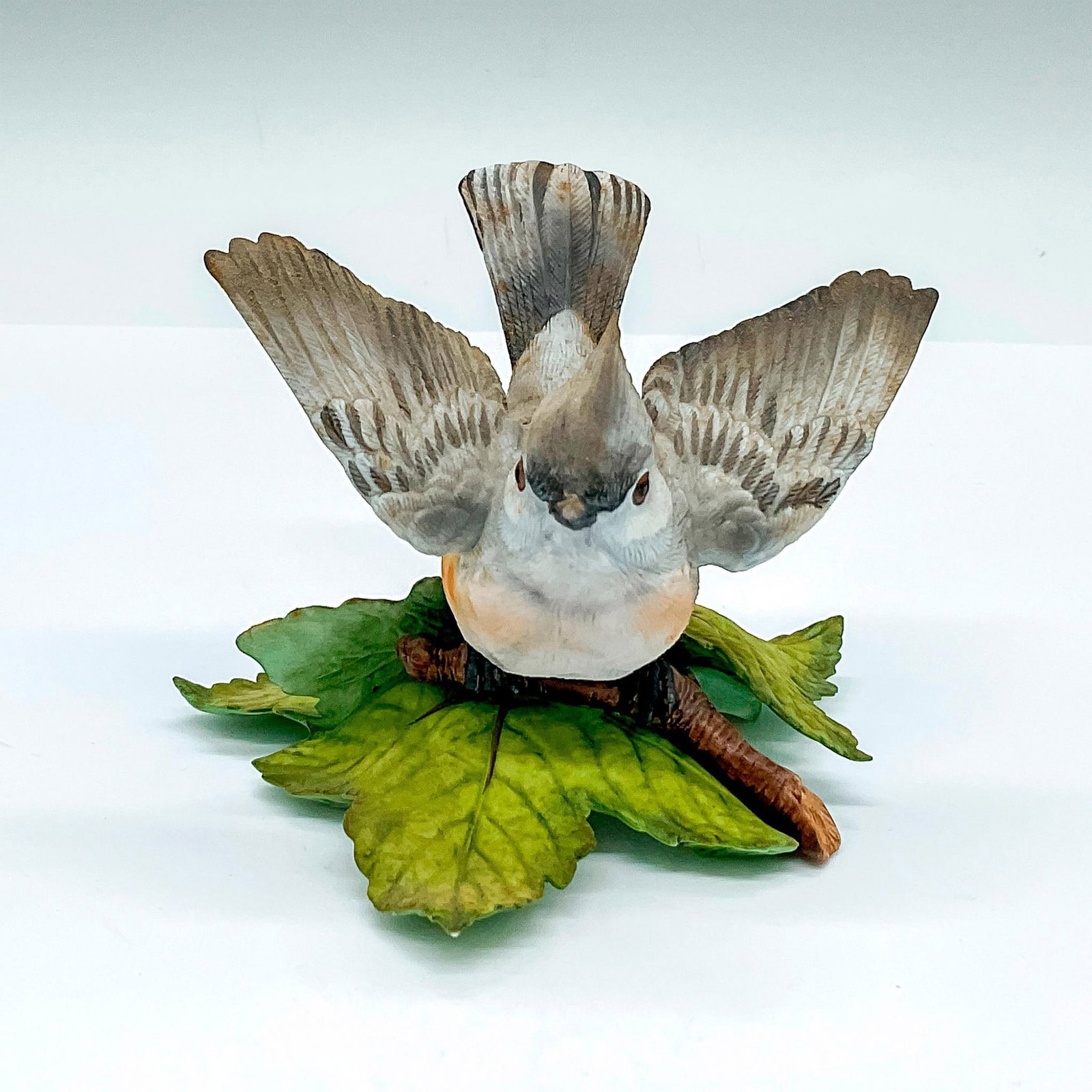 Lenox Fine Porcelain Figurine, Tufted Titmouse: An adorable small gray bird perched on a leafy branch. Lenox backstamp. Dimensions: 4.5"L x 4.25"W x 3"H Manufacturer: Lenox