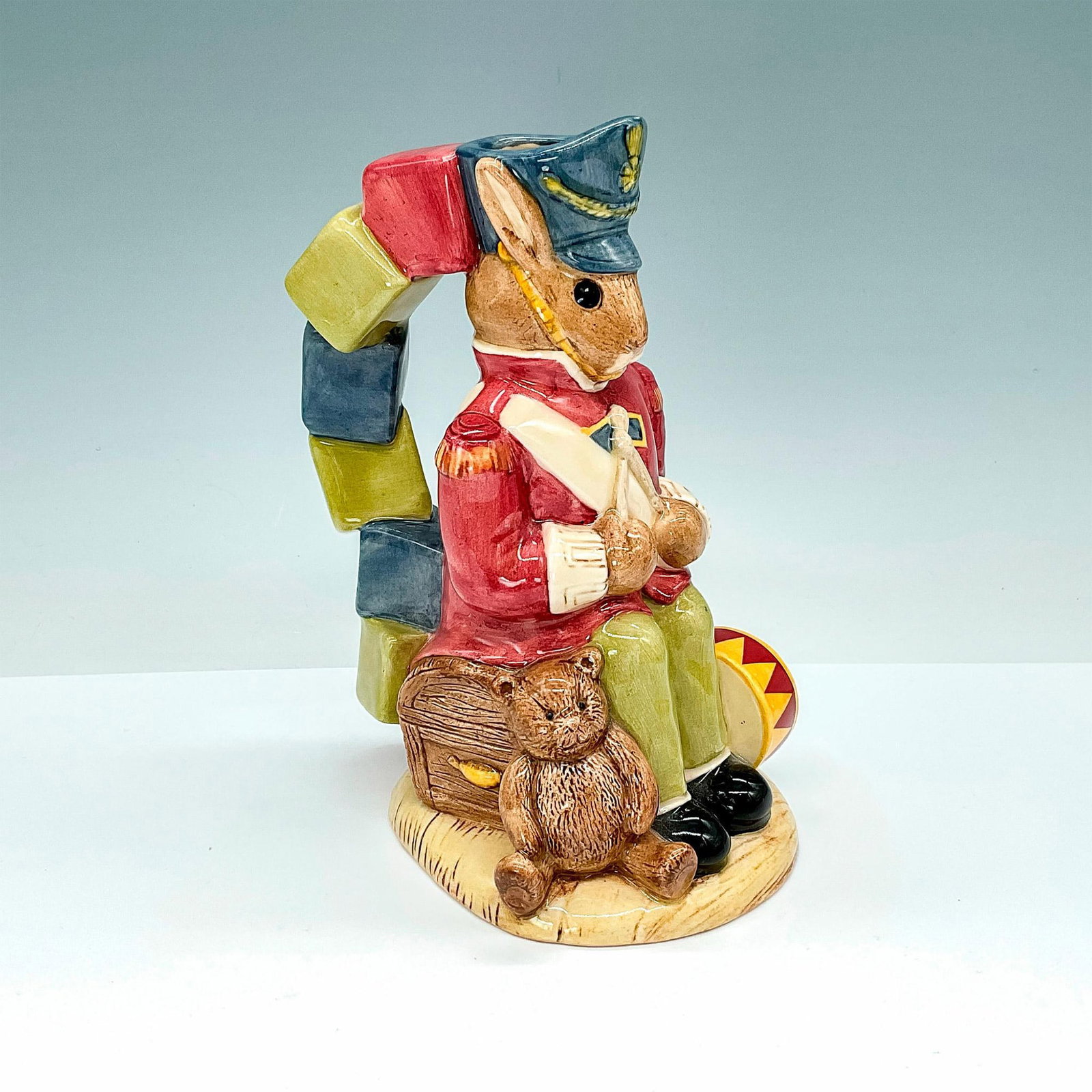 Royal Doulton Toby Jug, Bunnykins Toy Soldier D7185: Bewitching toby jug that depicts bunny dressing as a soldier with toys and colored bricks as handle. Royal Doulton backstamp. Dimensions: 5.5"L x 4"W x 6.75"H Edition Number: 239/1500 Manufacturer: Ro