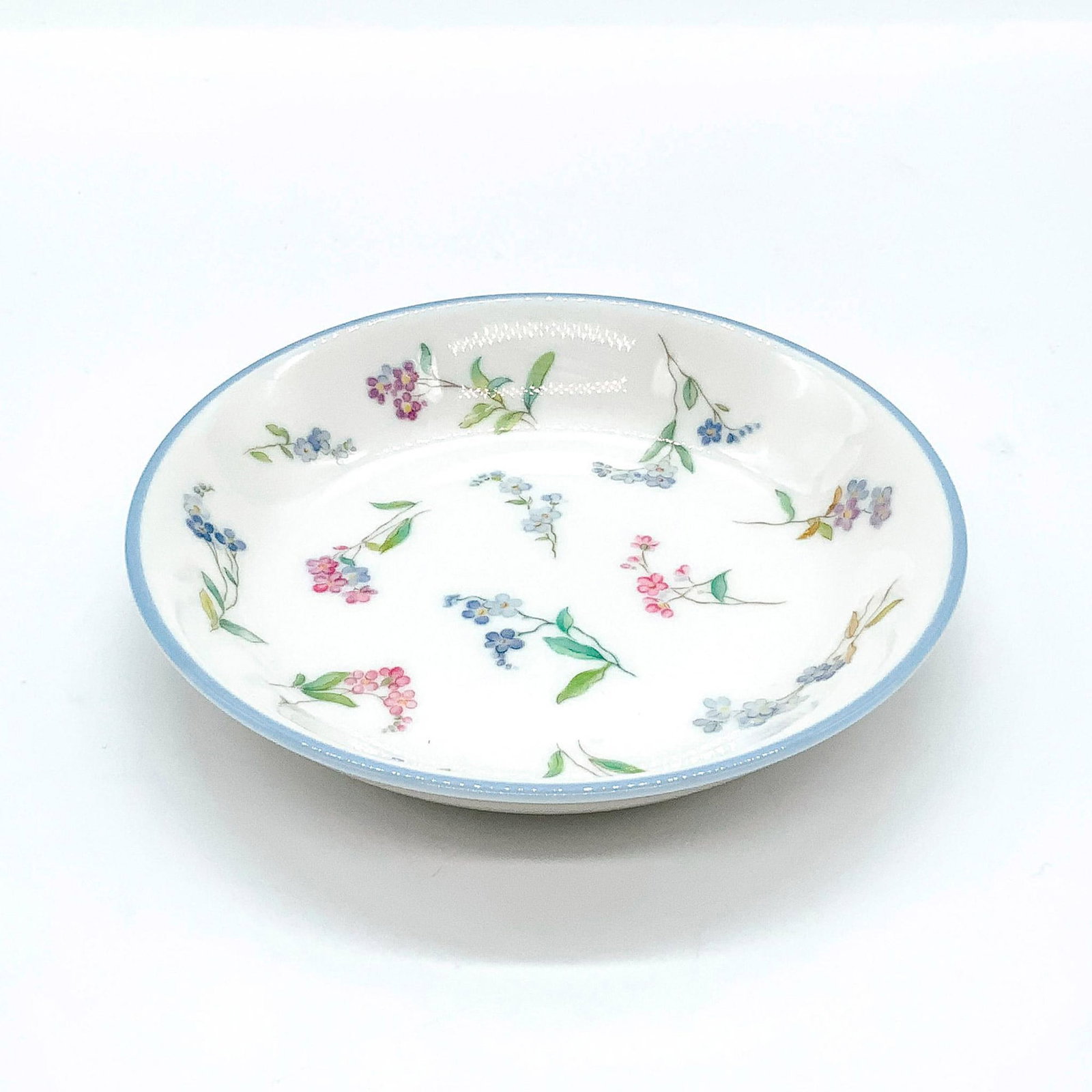 Royal Worcester Round Pin Tray, Forget Me Not: Beautifully decorated with delicate pink and blue floral pattern and blue trim to rim. Royal Worcester backstamp. Fine bone china. Issued: 1985-1997 Dimensions: 0.75"H x 4"Dia. Manufacturer: Royal Wor