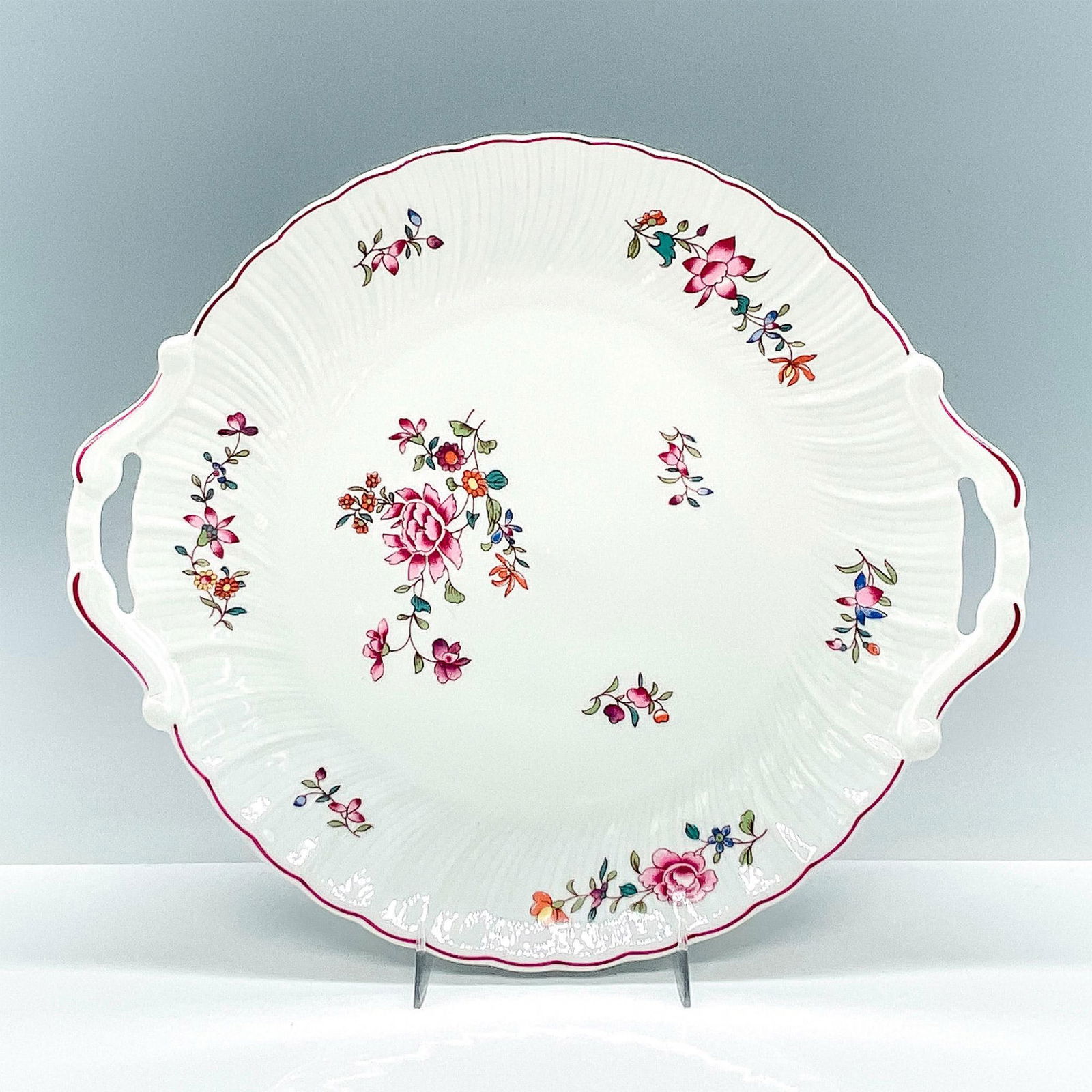Bernardaud Limoges Porcelain Platter: A vintage Bernardaud Lowestoft cake plate, showcasing charming pink and red flowers on a swirled dish design, and featuring convenient handles for easy serving. Bernardaud Limoges backstamp. Issued: 2