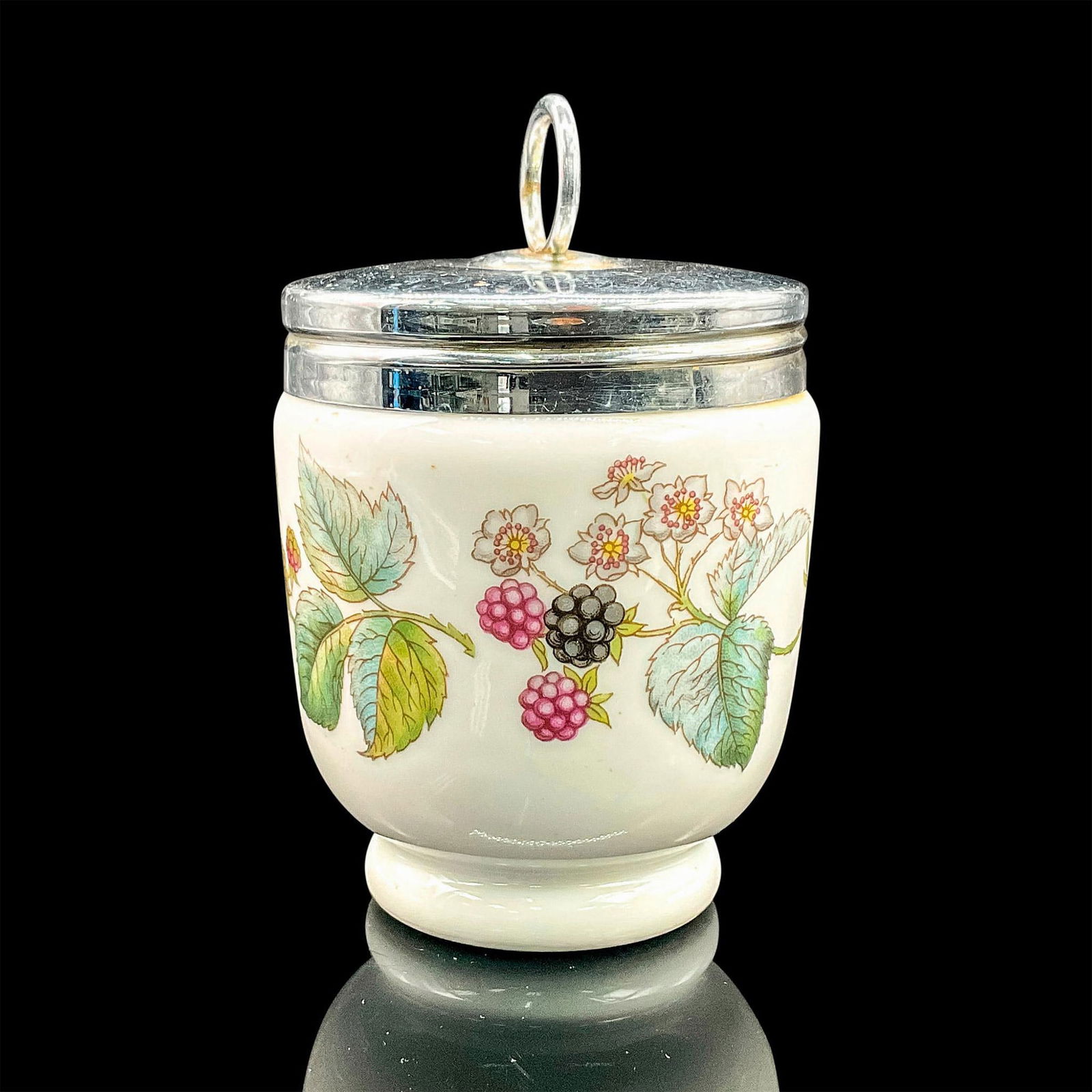 Royal Worcester Egg Coddler, Berries and Flowers: White porcelain oven-safe egg cup with silvertone lid and berries and floral design. Royal Worcester backstamp. Dimensions: 4.25"H x 2.5"dia Manufacturer: Royal Worcester Country of Origin: England