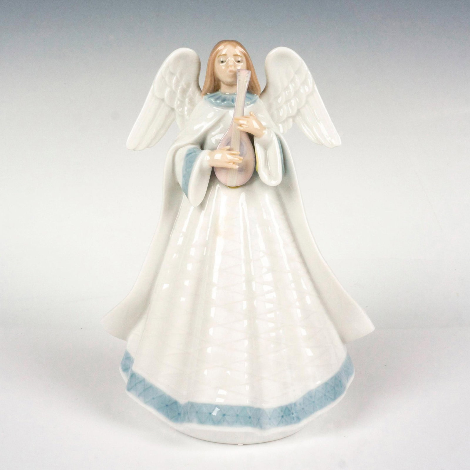 Angelic Melody 1005963 - Lladro Porcelain Figurine: Glossy finish; Lladro backstamp. Includes original box. Box measures 7.5"L x 11.75"W x 6"H. Artist: Francisco Catala Issued: 1993 - 1993 Dimensions: 7.25"H Manufacturer: Lladro Country of Origin: