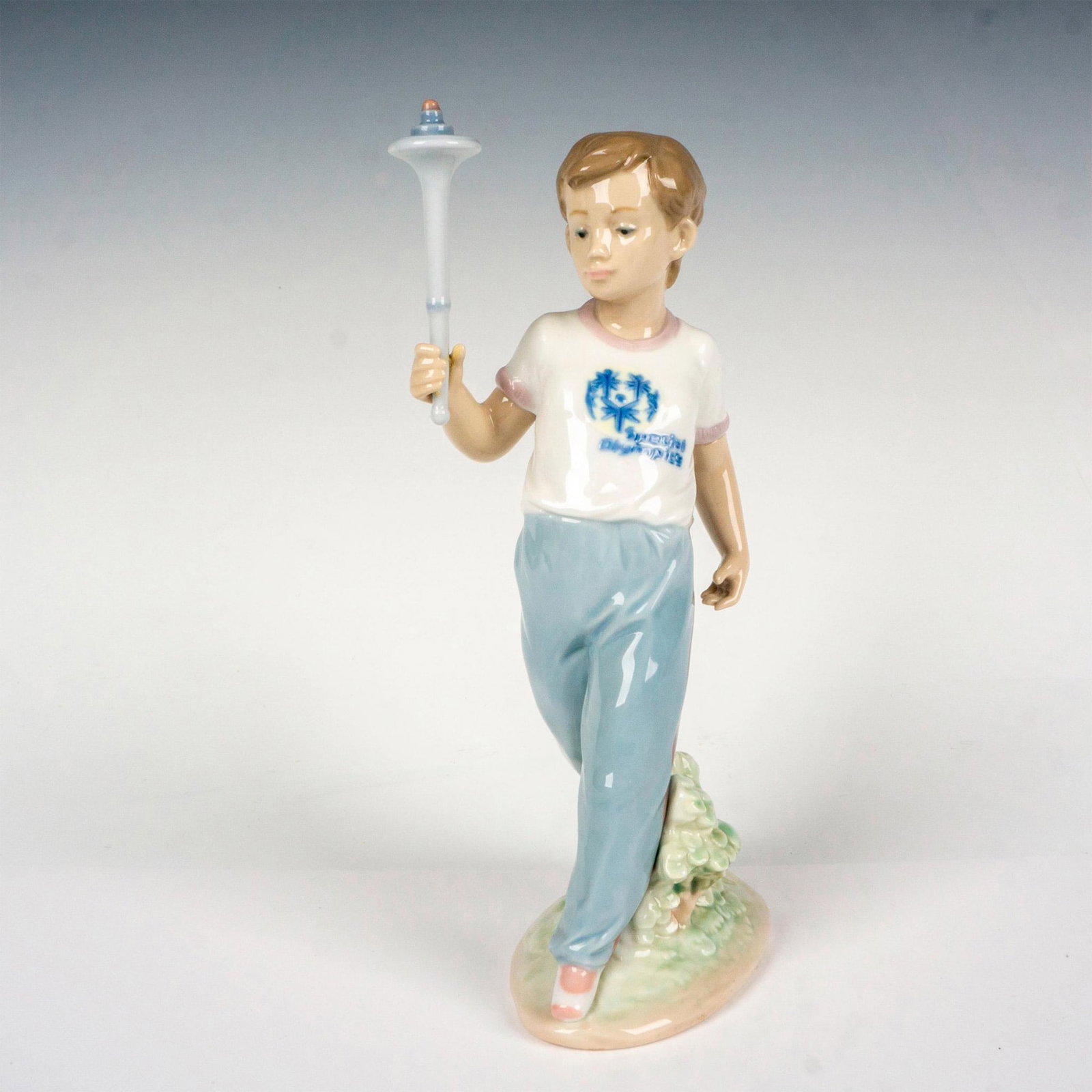 Courage (Spec Olympic) 1007522 - Lladro Porcelain Figurine: Glossy finish; Lladro backstamp. Includes original box. Box measures 7.5"L x 13"W x 6"H. Artist: Antonio Ramos Issued: 1993 - 1996 Dimensions: 8.5"H x 3.25"W Manufacturer: Lladro Country of Origin: