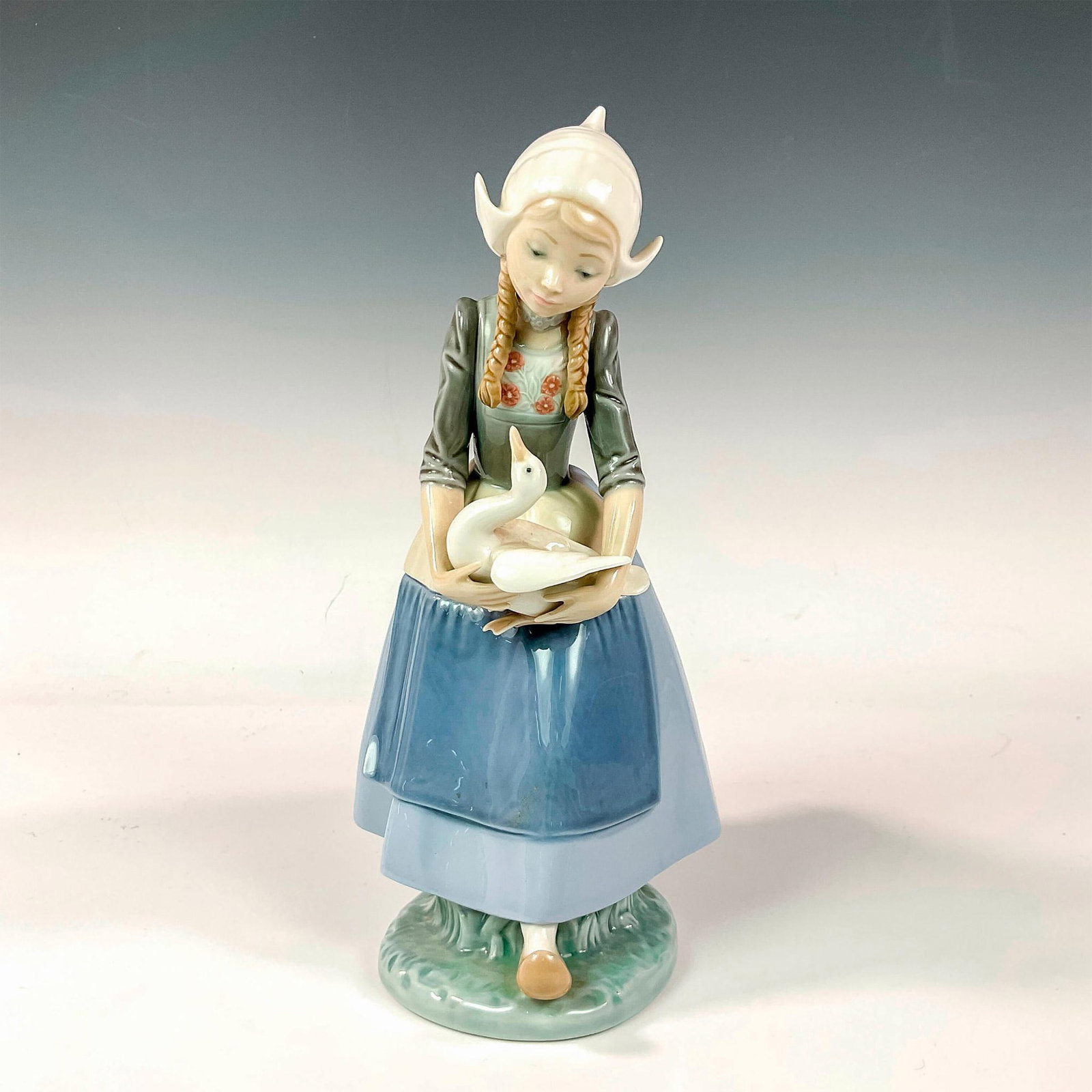 Dutch Girl With Duck 1005066 - Lladro Porcelain Figurine: Glossy finish; Lladro backstamp. Artist: Francisco Catala Issued: 1980 - 1985 Dimensions: 9.75"H Manufacturer: Lladro Country of Origin: Spain