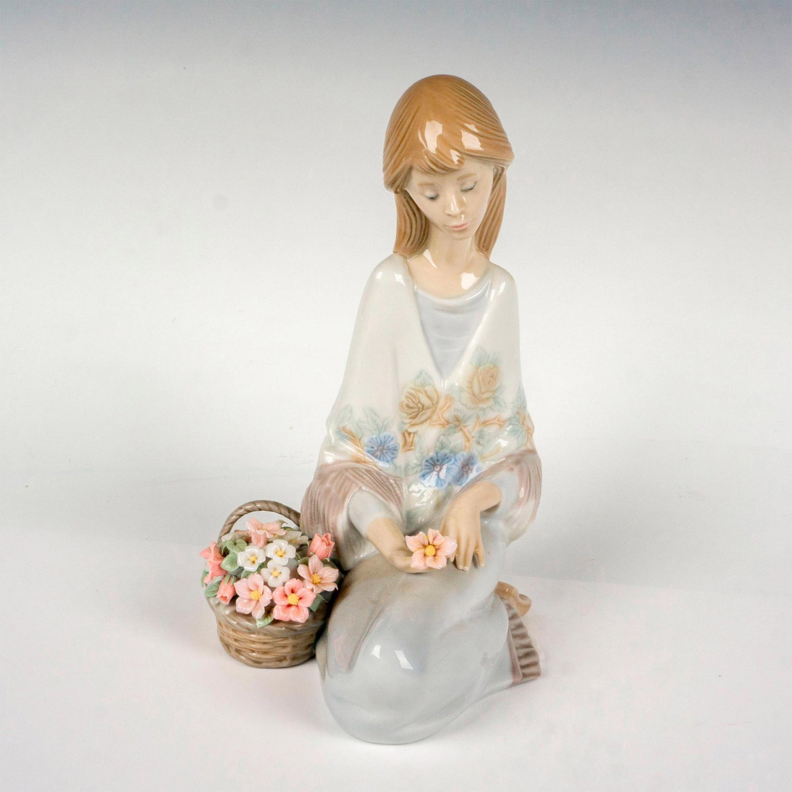 Flower Song 1007607 - Lladro Porcelain Figurine: Glossy finish; Lladro backstamp. Artist: Juan Huerta Issued: 1988 - 1989 Dimensions: 7.5"H x 5.5"W Manufacturer: Lladro Country of Origin: Spain