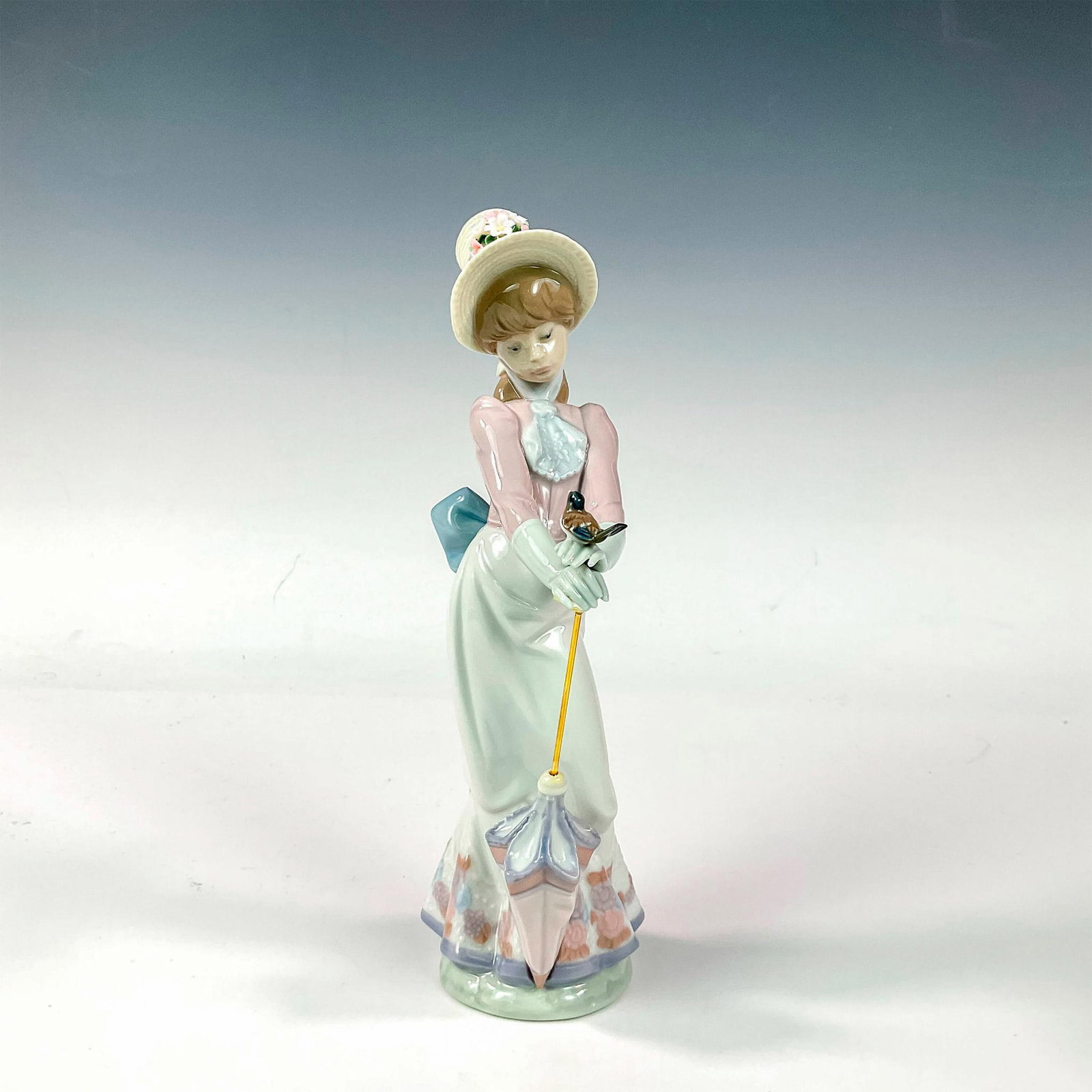 Garden Song 1007618 - Lladro Porcelain Figurine: Glossy finish; Lladro backstamp. Artist: Juan Huerta Issued: 1992 - 1992 Dimensions: 8.75"H Manufacturer: Lladro Country of Origin: Spain