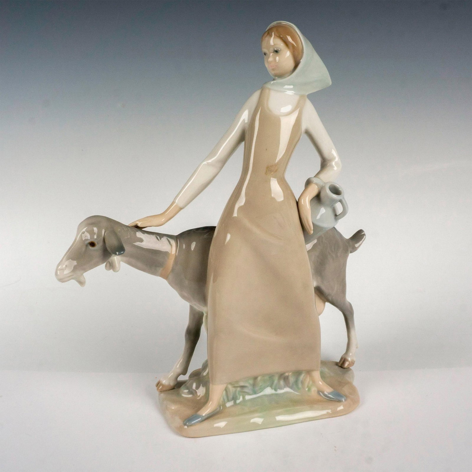 Girl With Pitcher 1004590 - Lladro Porcelain Figurine: Glossy finish; Lladro backstamp. Artist: Alfredo Ruiz Issued: 1969 - 1981 Dimensions: 10.5"H Manufacturer: Lladro Country of Origin: Spain