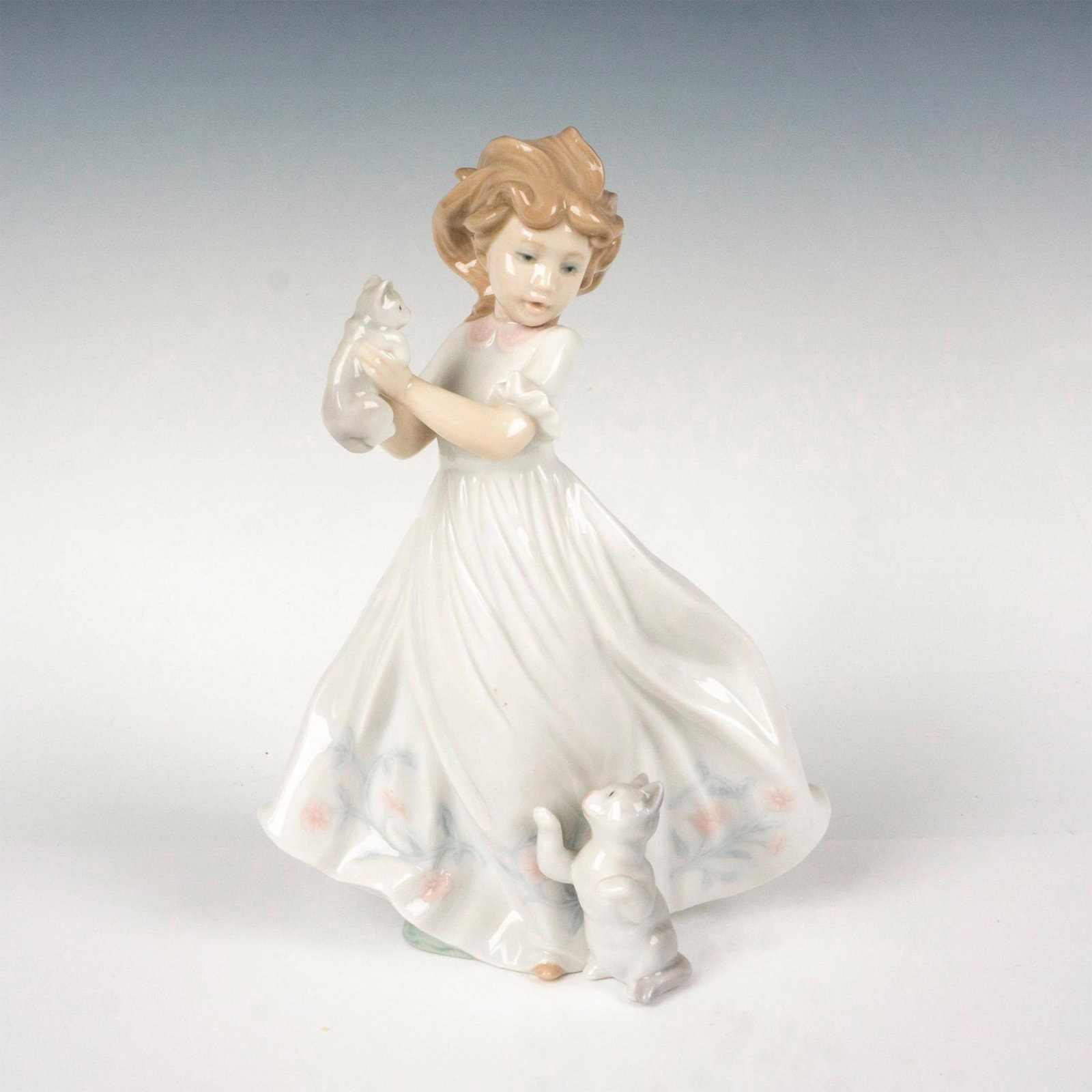 Kittens Gathering 1006941 - Lladro Porcelain Figurine: Glossy finish; Lladro backstamp. Artist: Regino Torrijos Issued: 2003 - 2003 Dimensions: 9.75"H x 6.75"W Manufacturer: Lladro Country of Origin: Spain