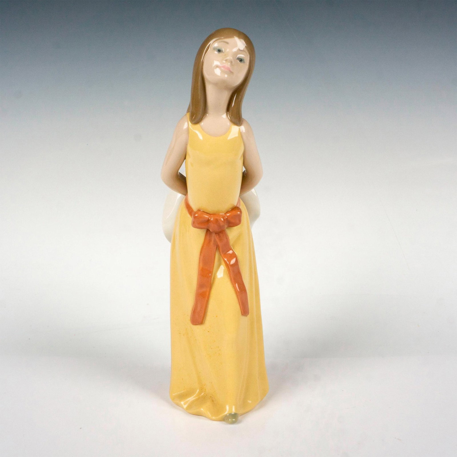 Naughty 1005006 - Lladro Porcelain Figurine: Glossy finish; Lladro backstamp. Artist: Francisco Catala Issued: 1978 - 1998 Dimensions: 9.75"H x 4"W Manufacturer: Lladro Country of Origin: Spain