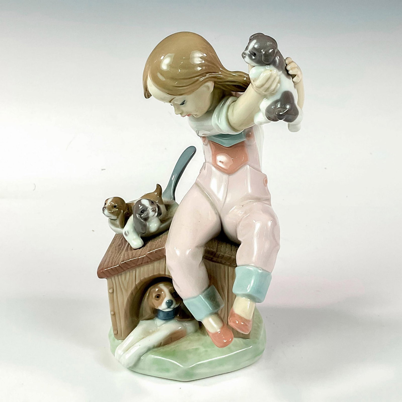 Pick of the Litter 1007621 - Lladro Porcelain Figurine: Glossy finish; Lladro backstamp. This item has its original box: 10.25"L x 9"W x 7.5"H. Artist: Salvador Debon Dimensions: 3.5"L x 4.5"W x 7.25"H Manufacturer: Lladro Country of Origin: Spain
