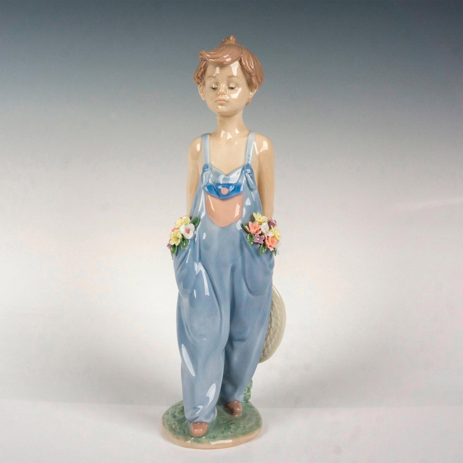 Pocket Full Of Wishes 1007650 - Lladro Porcelain Figurine: Glossy finish; Lladro backstamp. Artist: Antonio Ramos Issued: 1997 - 1997 Dimensions: 10.25"H x 3.5"W Manufacturer: Lladro Country of Origin: Spain