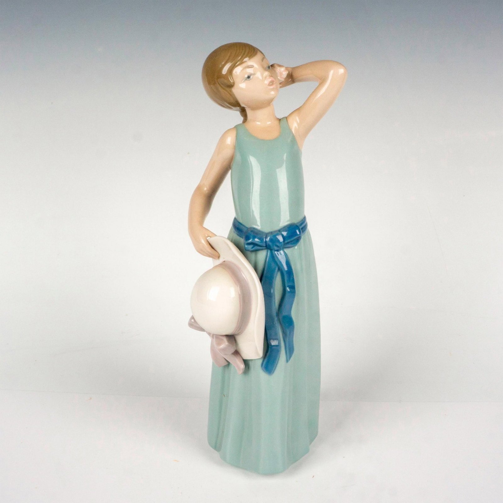 Prissy 1005010 - Lladro Porcelain Figurine: Glossy finish; Lladro backstamp. Artist: Francisco Catala Issued: 1978 - 1997 Dimensions: 9.75"H x 3.5"W Manufacturer: Lladro Country of Origin: Spain