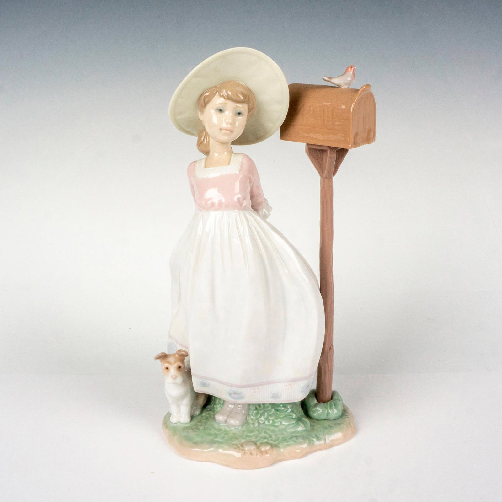 Waiting For Your Letter 1006852 - Lladro Porcelain Figurine: Glossy finish; Lladro backstamp. Artist: Regino Torrijos Issued: 2002 - 2004 Dimensions: 9.75"H x 5.5"W Manufacturer: Lladro Country of Origin: Spain