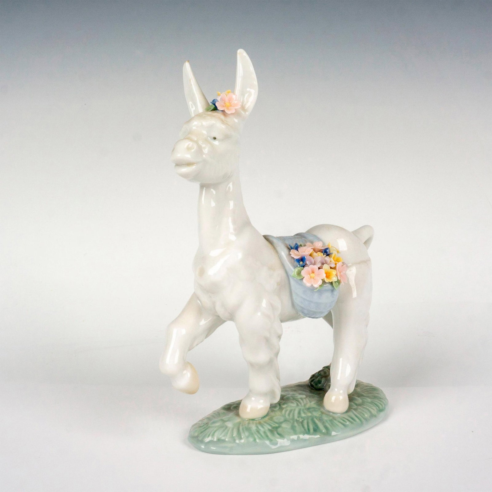 Parading Donkey 1006573 - Lladro Porcelain Figurine: Glossy finish; Lladro backstamp. Includes original box. Box measures 8.25"L x 9"W x 5.5"H. Artist: Juan Huerta Issued: 1998 - 2000 Dimensions: 6.75"H Manufacturer: Lladro Country of Origin: Spain<