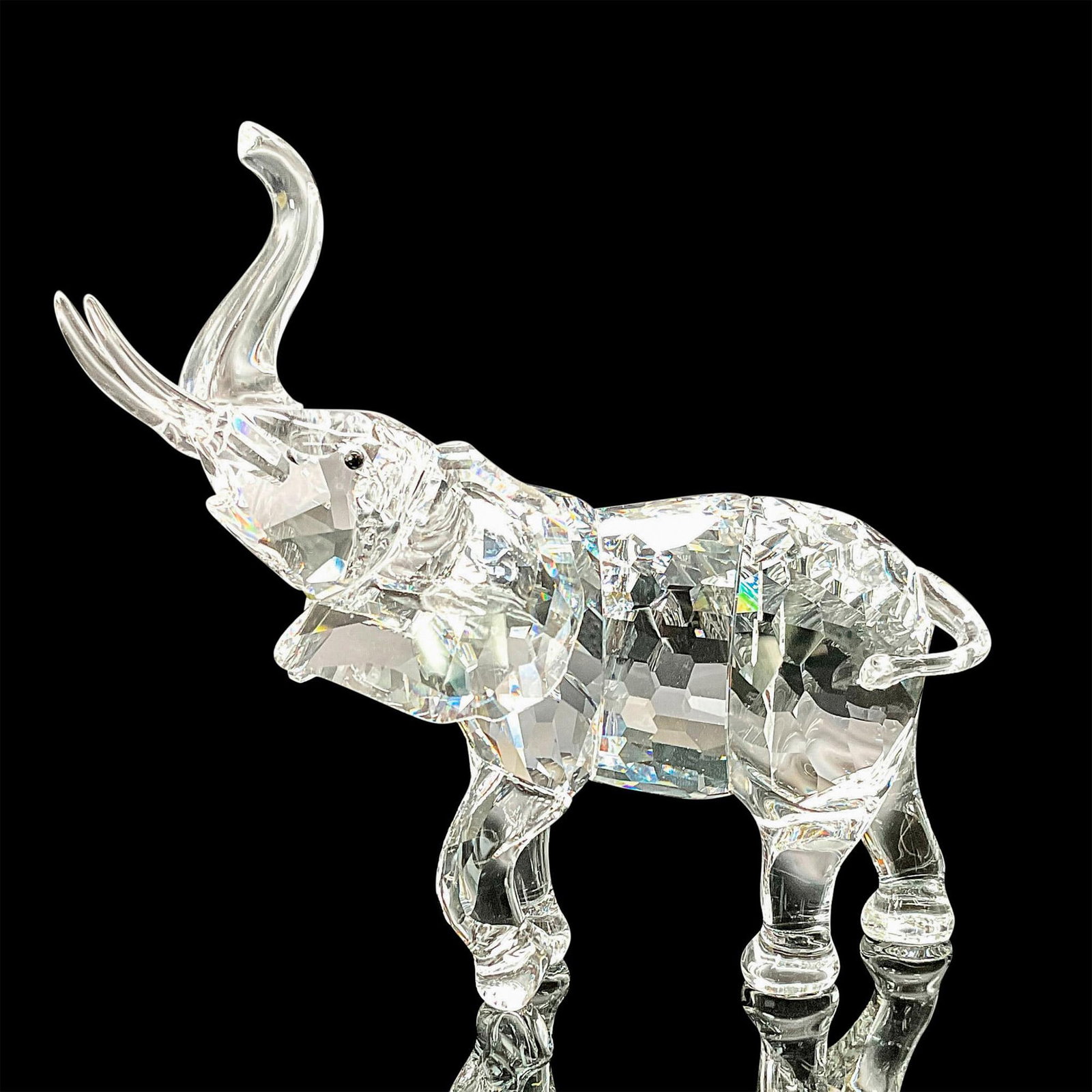 Swarovski Crystal Figurine, Mother Elephant: This Swarovski crystal mother elephant belonged to the Rare Encounters theme group. She flaunts a faceted clear crystal body and Jet crystal eyes. Her legs, trunk, tail and tusks are in unfaceted crys
