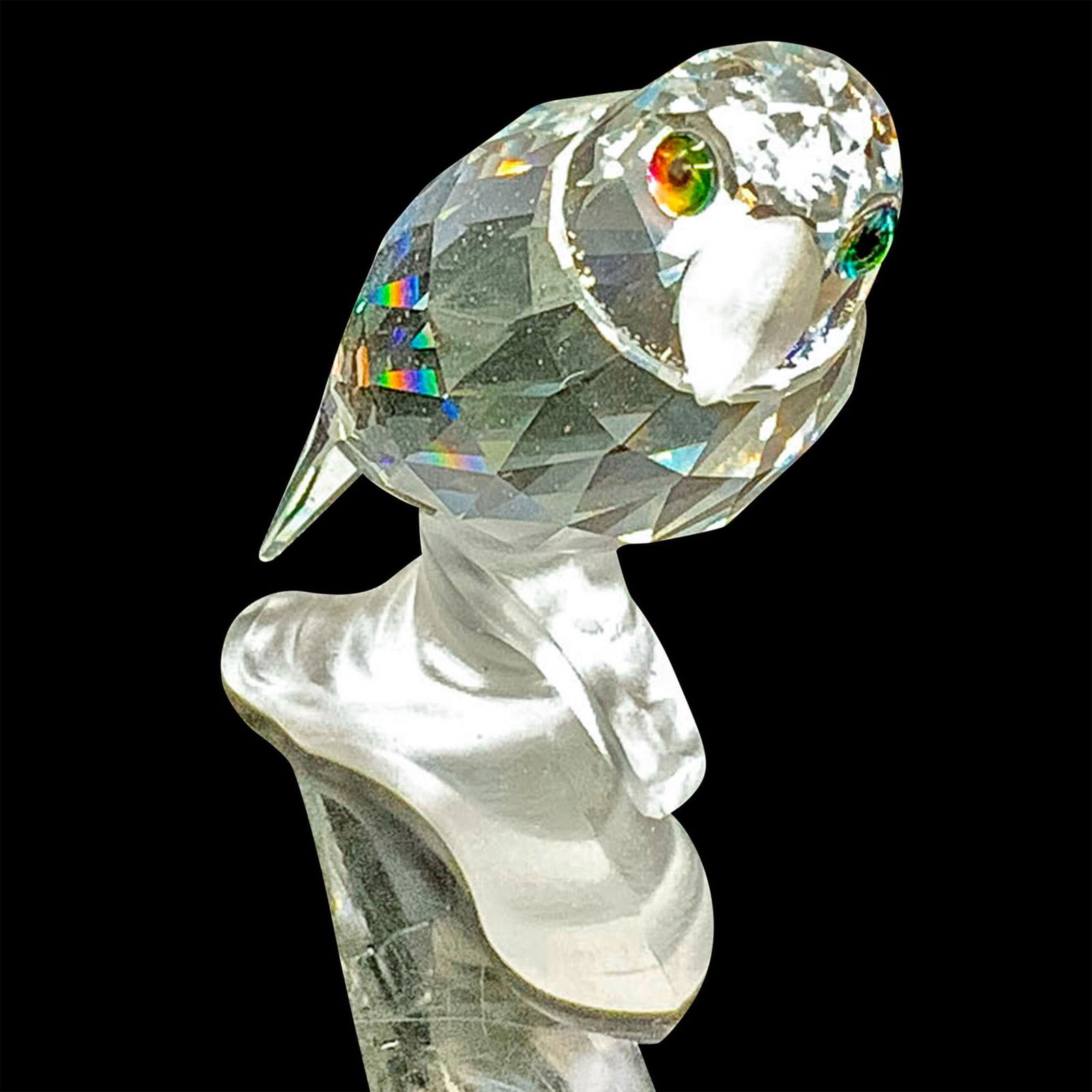 Swarovski Crystal Figurine, Parrot on Branch 119443: This parrot is made from clear crystal, has a frosted beak, and sits on a frosted base. The item includes its original box measuring 3.25"dia. x 5"H. Artist: Michael Stamey Dimensions: 1.75"L x 1"W x