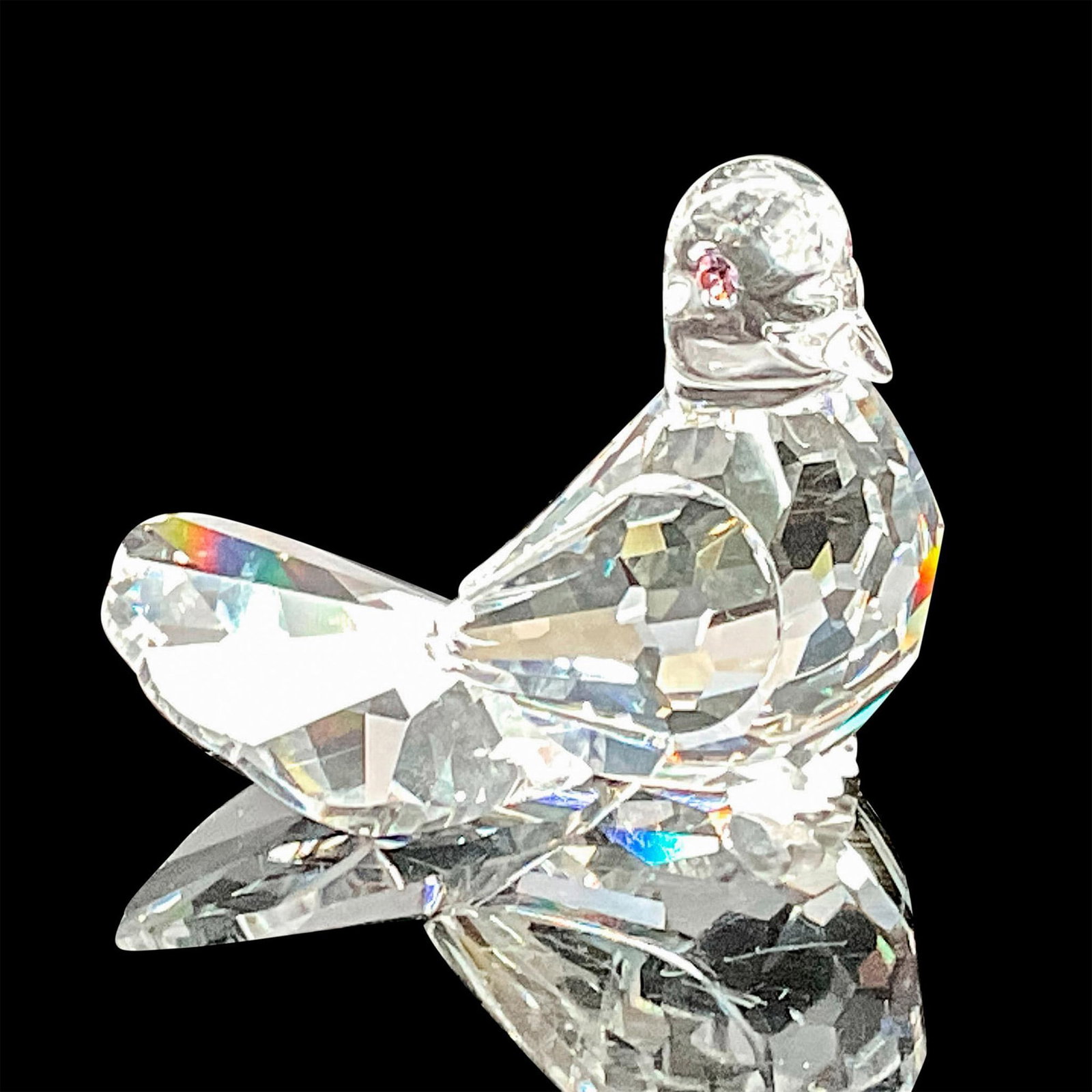 Swarovski Silver Crystal Figurine, Dove: This Swarovski crystal dove was part of the Feathered Friends collection. It has a clear crystal faceted body, a fan shaped tail, frosted feet and pink eyes. Swarovski etched backstamp. This item has 