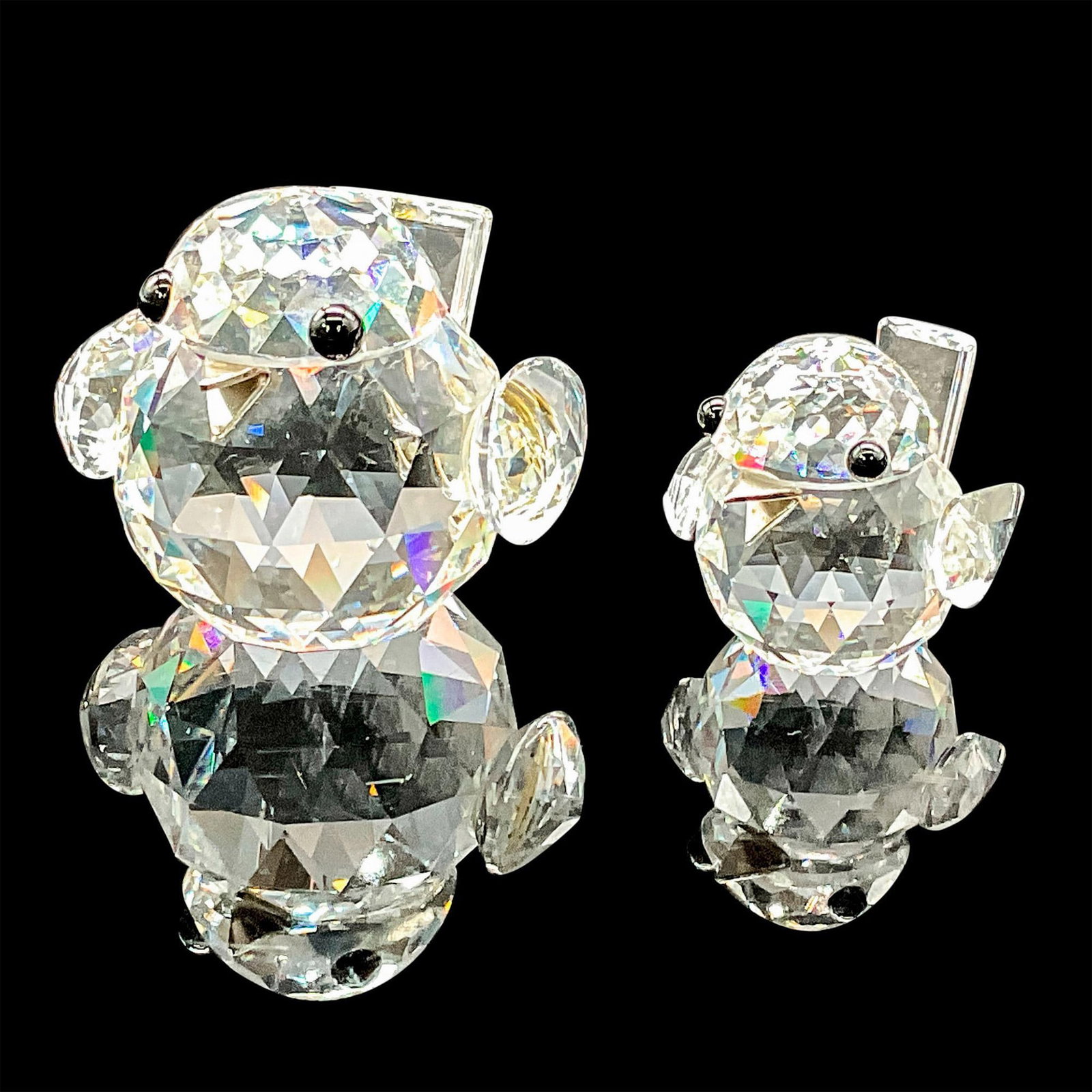 Pair of Swarovski Crystal Figurines, Sparrows: These charming sparrow figurines features a crystal tail, complemented by black eyes and a silver beak. This item has its original box for the mini which measures 3"H x 2.5"dia. Swarovski etched backs