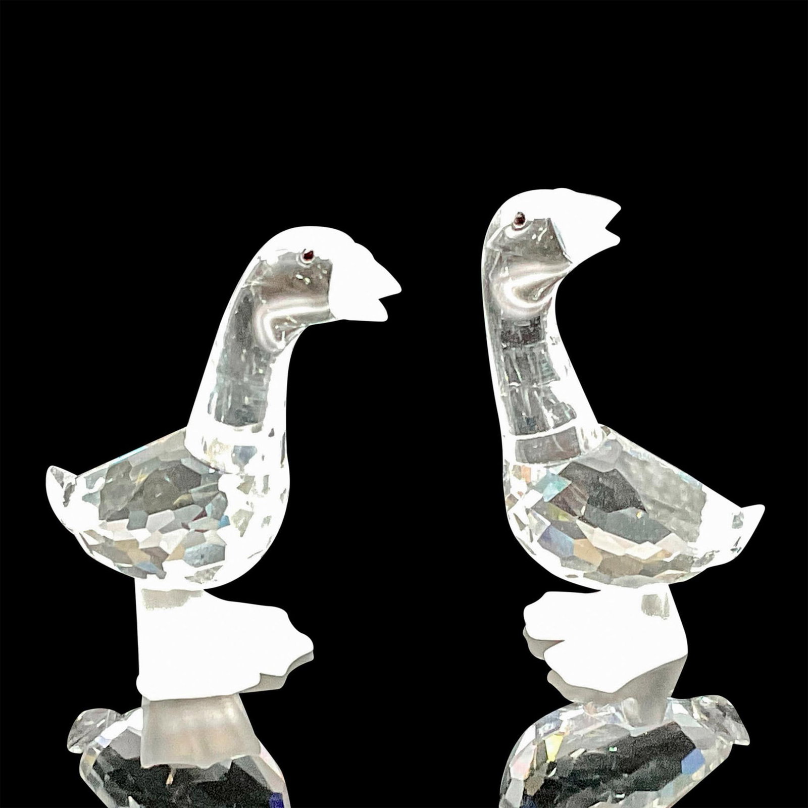 Pair of Swarovski Silver Crystal Figurines, Geese: These Swarovski crystal geese were part of the Barnyard Friends theme group. Their bodies are made from clear faceted crystal, with black eyes, and the beak and feet are in frosted crystal. Swarovski 