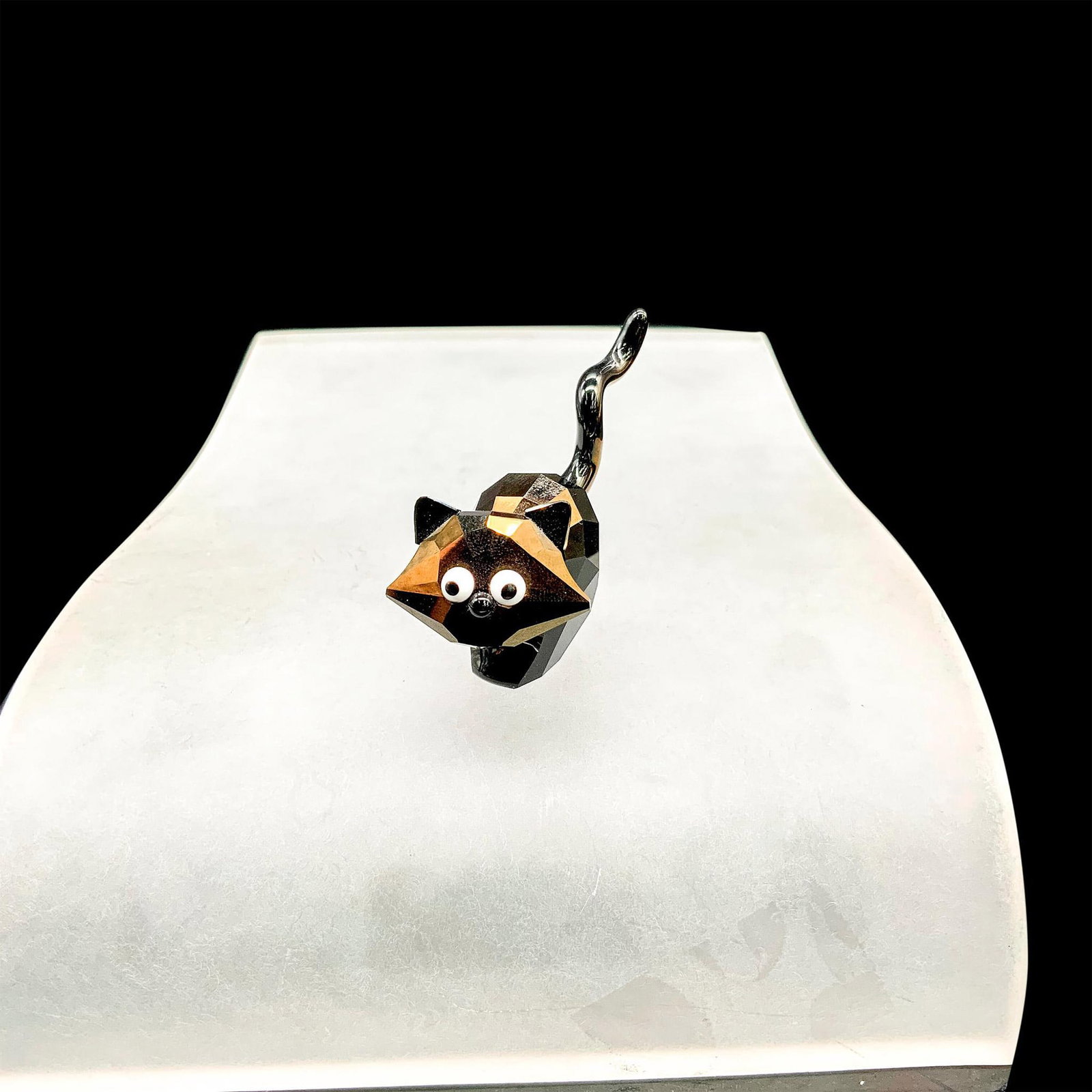 Swarovski Crystal Figurine, Lovlots Cat, Theo 995010: This limited edition retired Swarovski crystal Theo the cat belongs to the House of Cats. It is designed in nut jet crystal with Chalk White crystal eyes and black printed pupils. The box measures 3.2