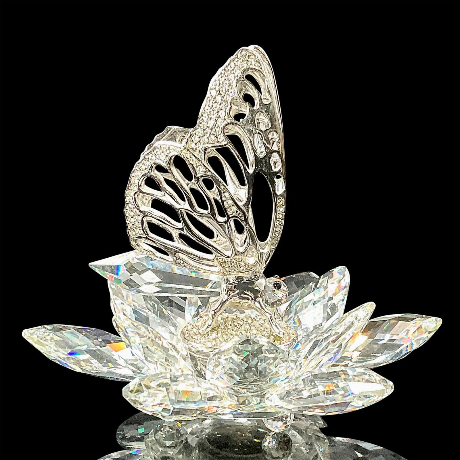 Swarovski Crystal Figurine, Butterfly In Flight: Swarovski crystal and rhodium butterfly is one of 6 members of the In-Flight group. The clear faceted crystal flower which makes up the base is identical on all 6 pieces and is set with clear crystal 