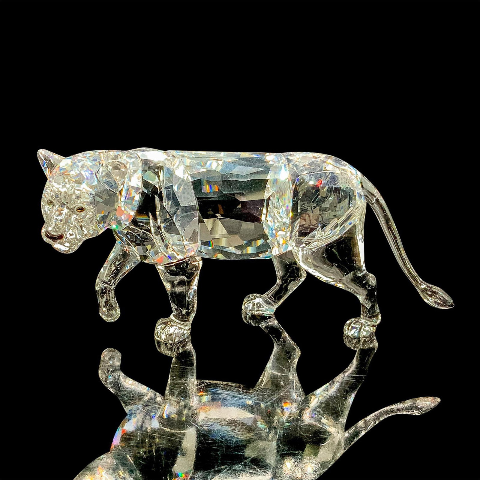 Swarovski Crystal Figurine, Lion Mother 1194085: Crafted in fully faceted clear crystal, this lioness sparkles brilliantly. She comes with her original box measuring 7.75"L x 7.75"W x 5.25"H. Artist: Dominic Schopf Issued: 2013-2015 Dimensions: 6"L 