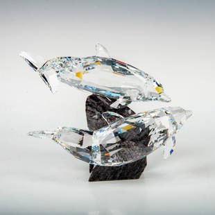 Swarovski Crystal Figurine, Dolphins 955350: This retired Swarovski Soulmate Dolphin sculpture was part of the Soulmates theme group. The dolphins are made from fully faceted clear crystal around a cut Vizag Blue Granite base with a protective f