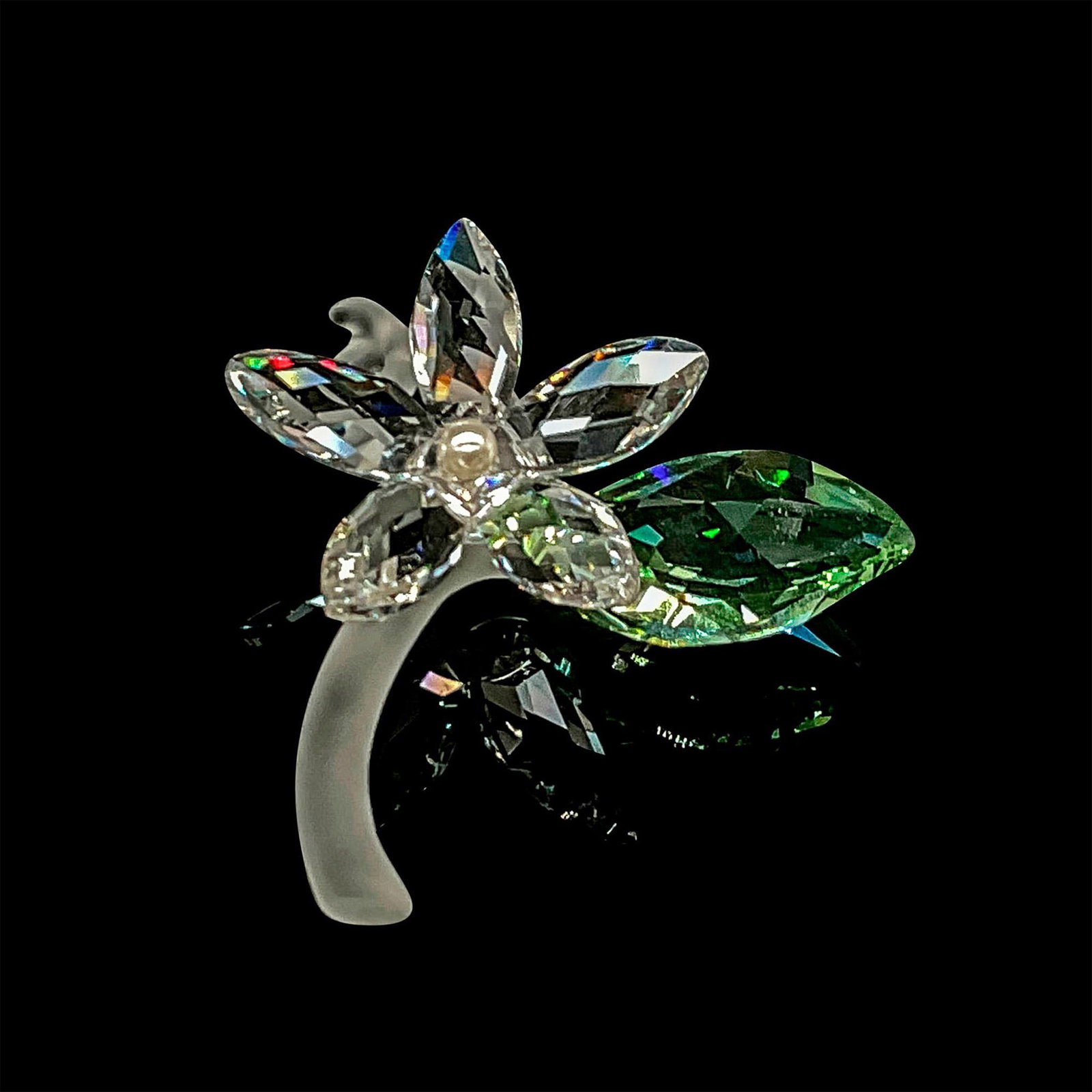 Swarovski Crystal Figurine, Jasmine Blossom Flower: Beautiful clear cut crystal flower with pearl center and green leaf on frosted stem. This item has its original box: 4"L x 4"W x 1.75"H. Issued: 20th century Dimensions: 2"L x 2.25"W x 1"H Manufacture