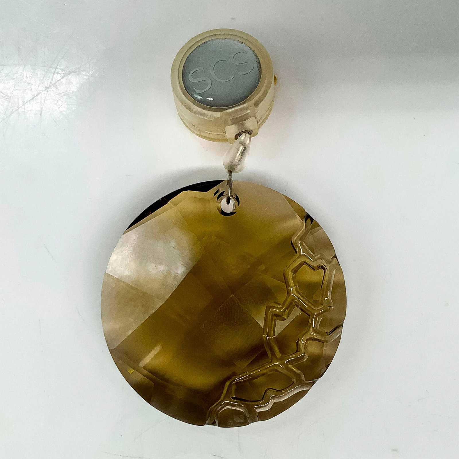 Swarovski Crystal Earth Ornament 1003284: A brown round crystal ornament with lines carved into the side to resemble rocks. Swarovski backstamp. This item has its original box. Dimensions of the original box: 3.75"L x 3.75"W x 1.25"H. Artist: