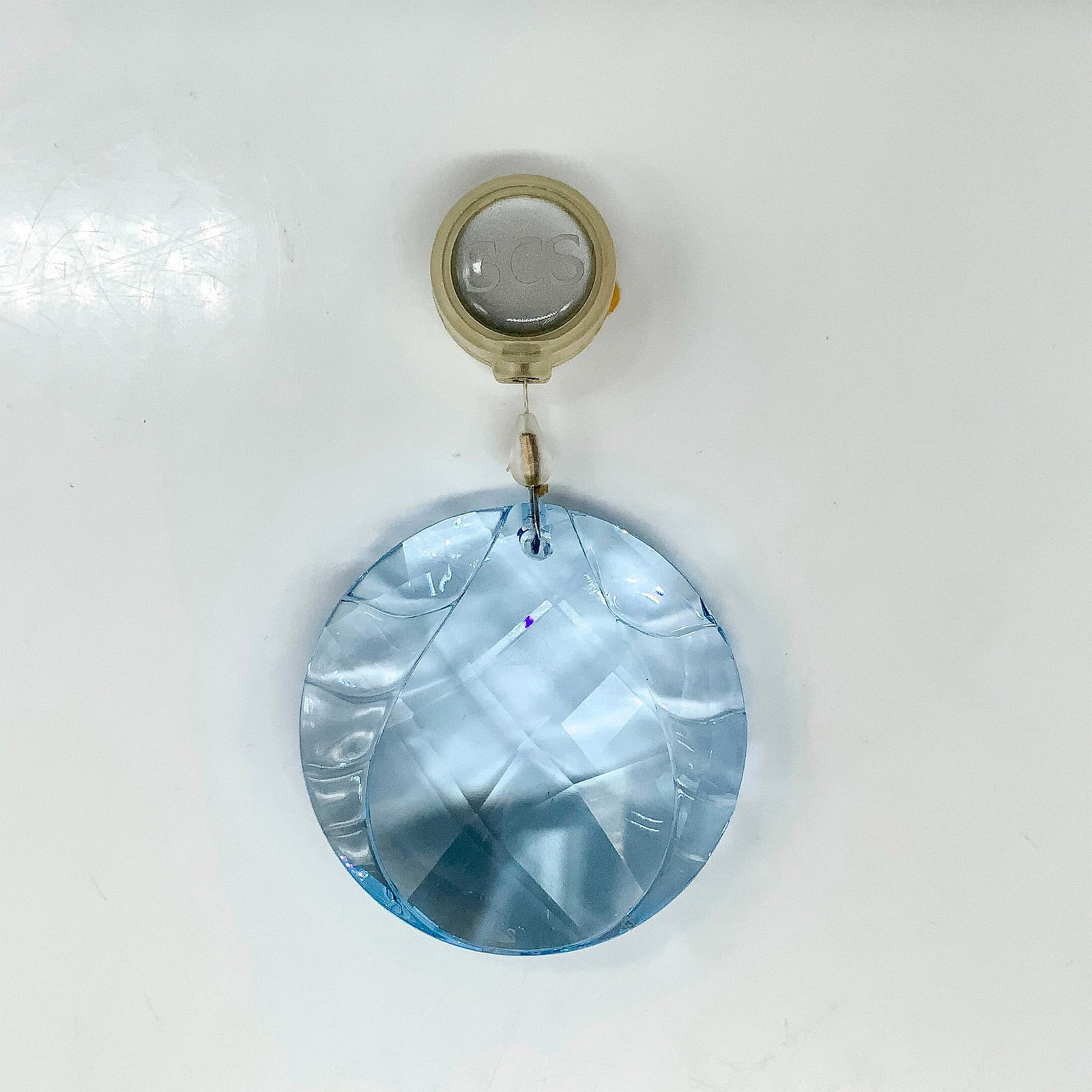 Swarovski Crystal Water Ornament 905545: A blue round crystal ornament with a tear drop carved into the center. Swarovski backstamp. This item has its original box. Dimensions of the original box: 3.75"L x 3.75"W x 1.25"H. Artist: Heinz Tabe