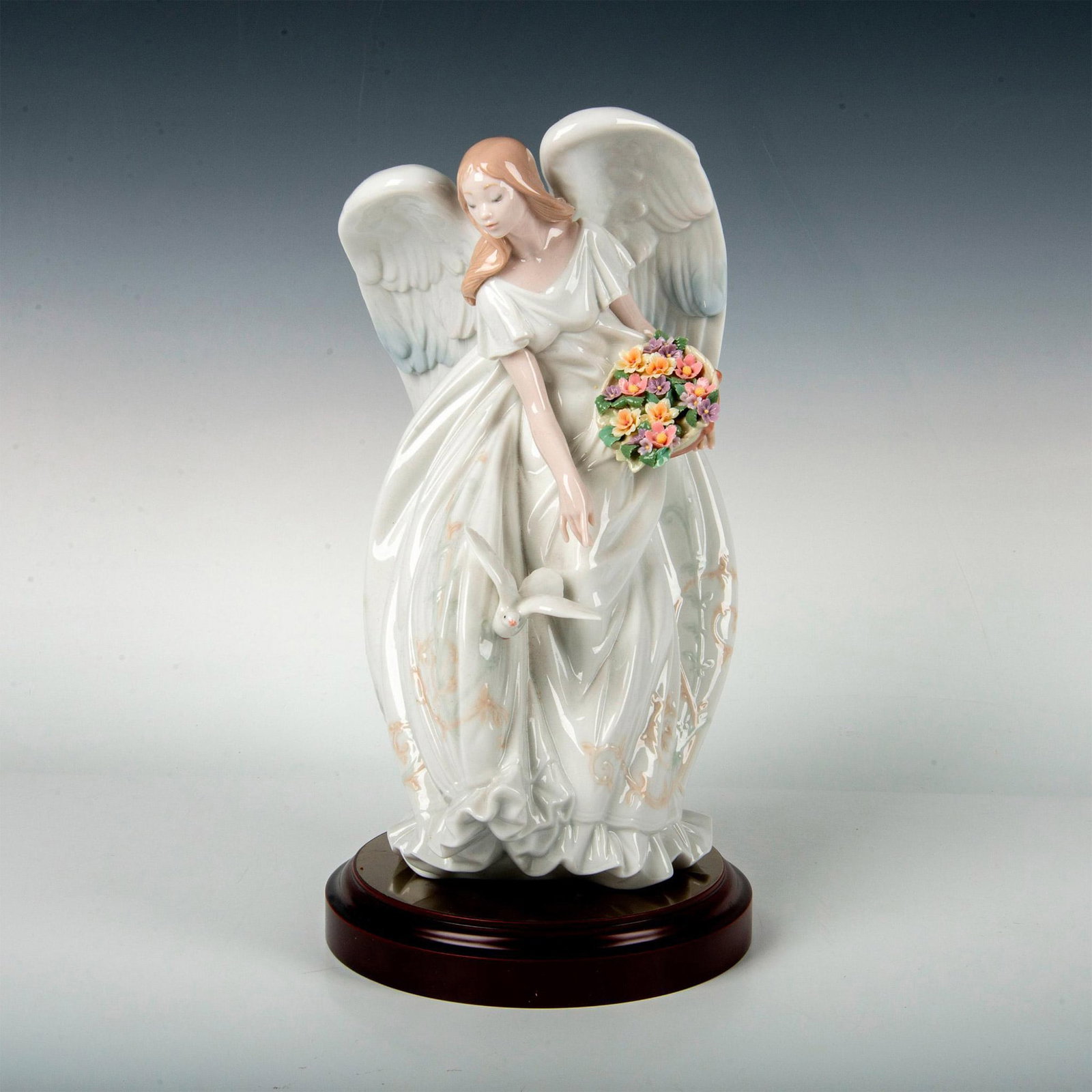 Flowers of Peace 1001867 - Lladro Porcelain Figurine: Retired figurine with a glossy finish and Lladro backstamp on bottom. The round wooden base measures 7.25"dia. x 1.25"H. This item has its original box: 19"L x 11"W x 12"H. Artist: Virginia Gonzalez I