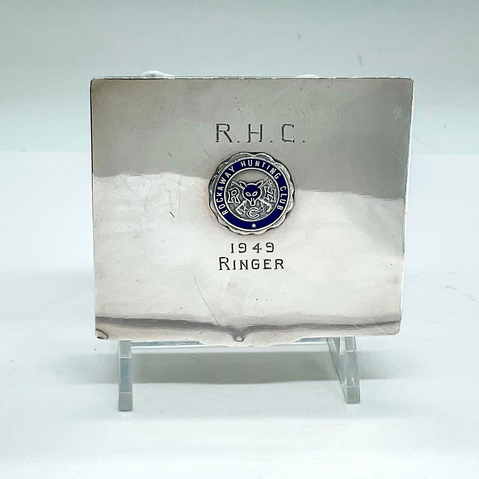 John Frick Rockaway Hunting Club Sterling Silver Box: Silver hinged lid box with raised Rockaway Hunting Club insignia and 1949 Ringer engraved on the lid. Sterling Silver 210 and John Frick stamped to the bottom. The inside of the box is lined with wood