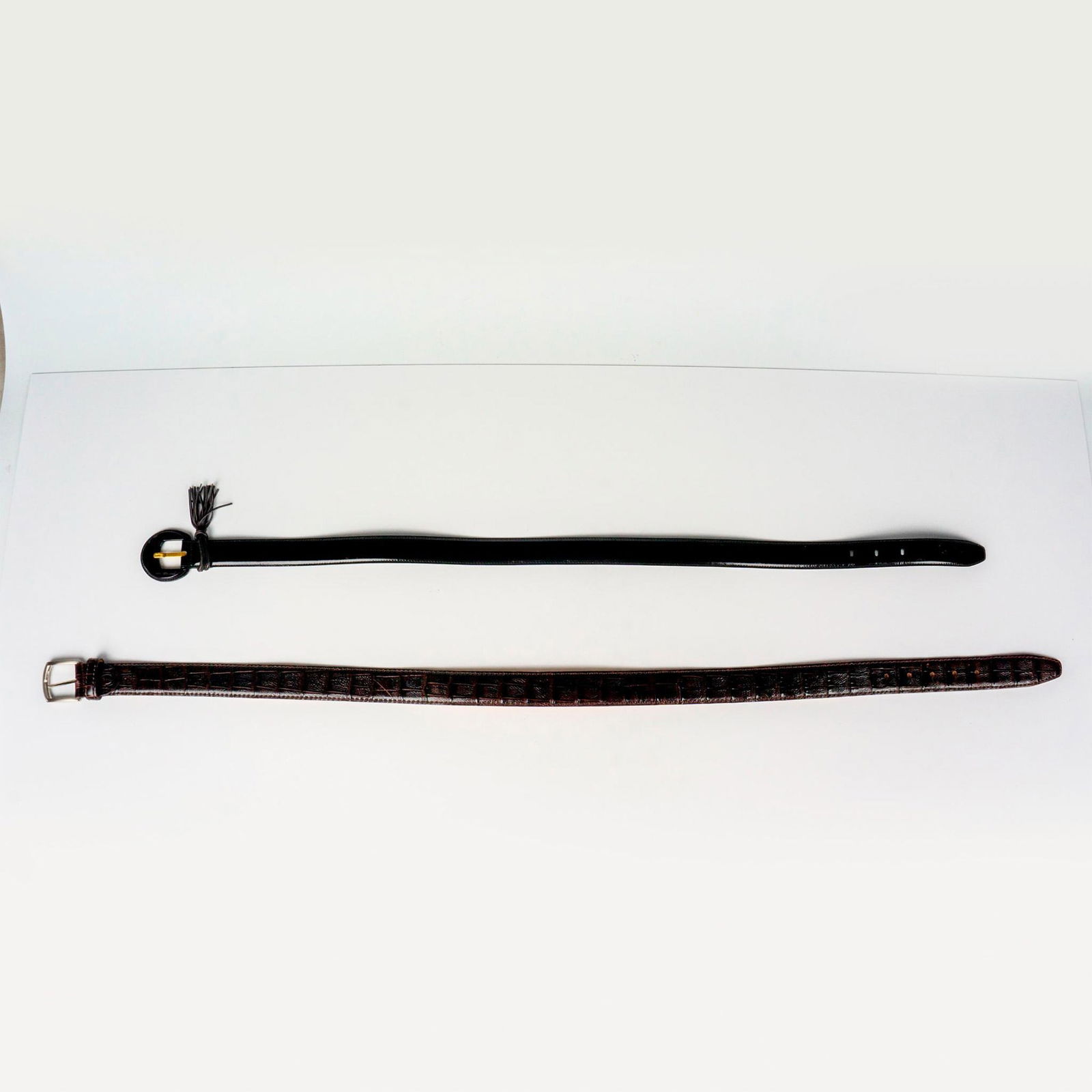 2pc Belts Ferragamo and Canali from Italy: Beautiful black blet with tasseled keeper stamped Salvatore Ferragamo made in Italy 5110, 35.5" long. Canali belt in brown leather with animal print design. Marked Canali Made in Italy, Genuine Leathe