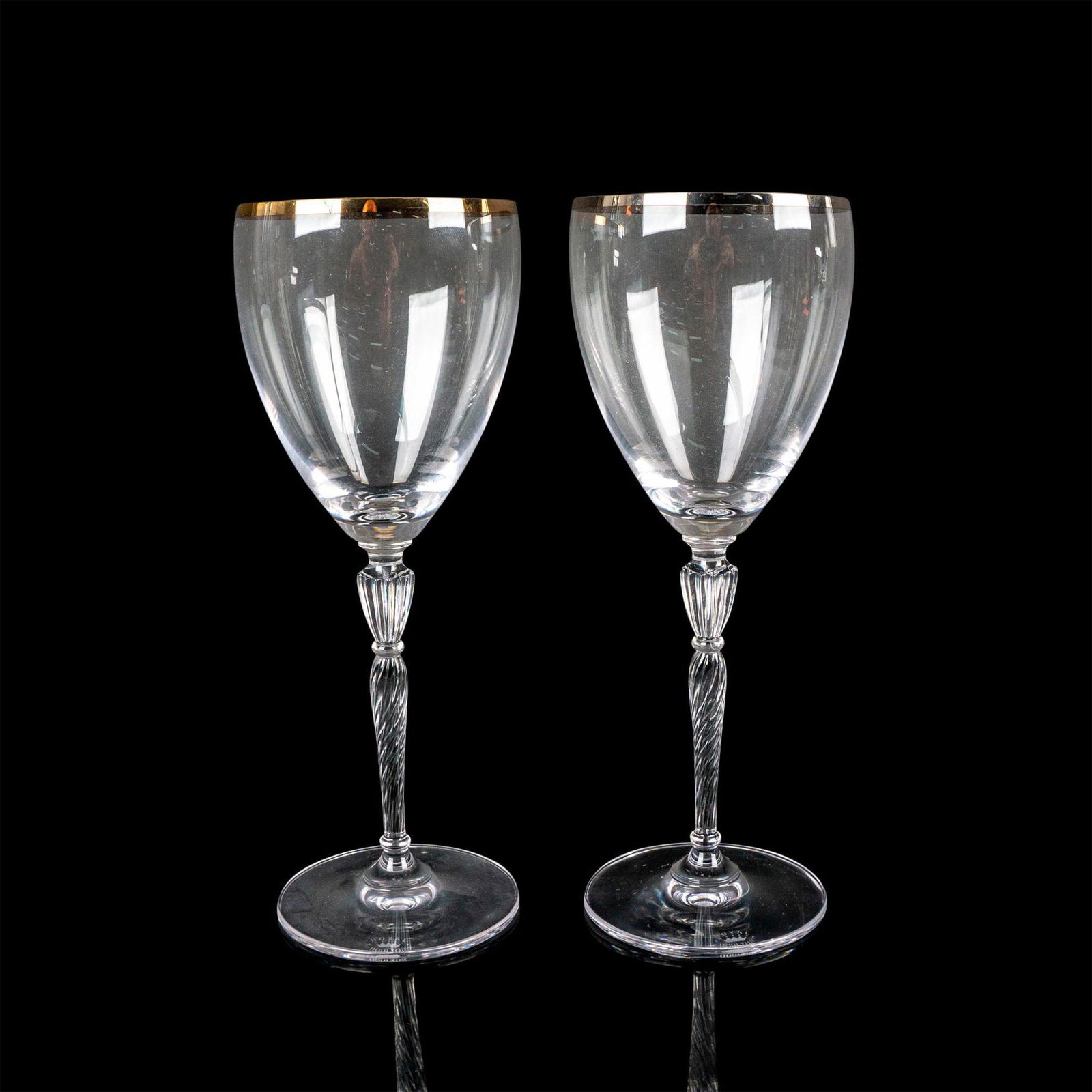 Pair of Royal Doulton Glass Water Goblets, Oxford: Elegant drinkware glasses with gold and platinum trimmed edge and ribbed stem. Royal Doulton etched backstamp. Issued: 1998-2004 Dimensions: 3"W x 8.5"H Manufacturer: Royal Doulton Country of Origin:
