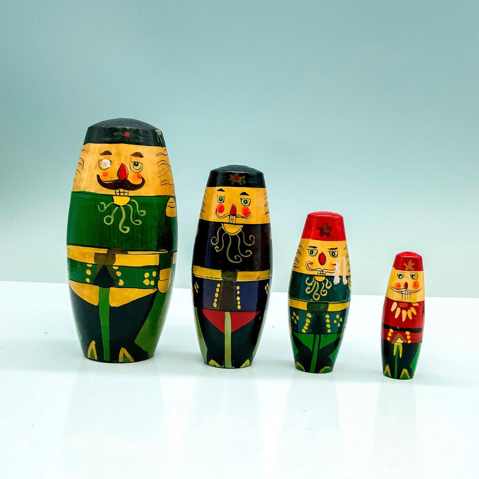 4pc Vintage Russian Nesting Dolls: A set of four wooden Russian nesting dolls that depict Russian soldiers in different uniforms. Dimensions of the largest item: 4.75"H x 2" dia.