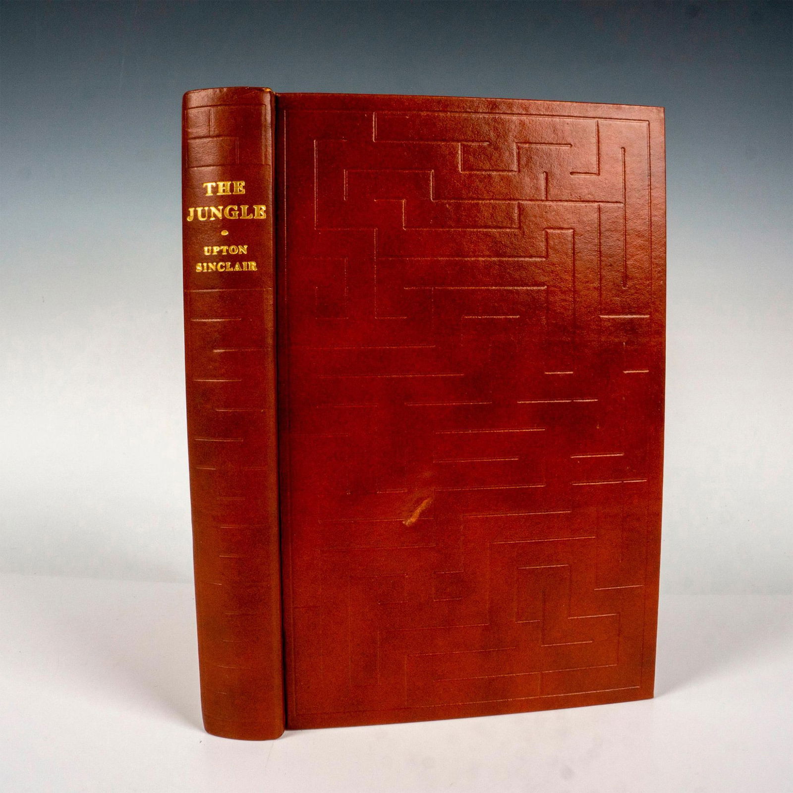 First Edition The Jungle, Book by Upton Sinclair: New York: The Heritage Press, 1965. First edition leather brown hardcover book with its original box sleeve. 334-pages of the political fiction with illustrations by Fletcher Martin. Artist: Upton Sin