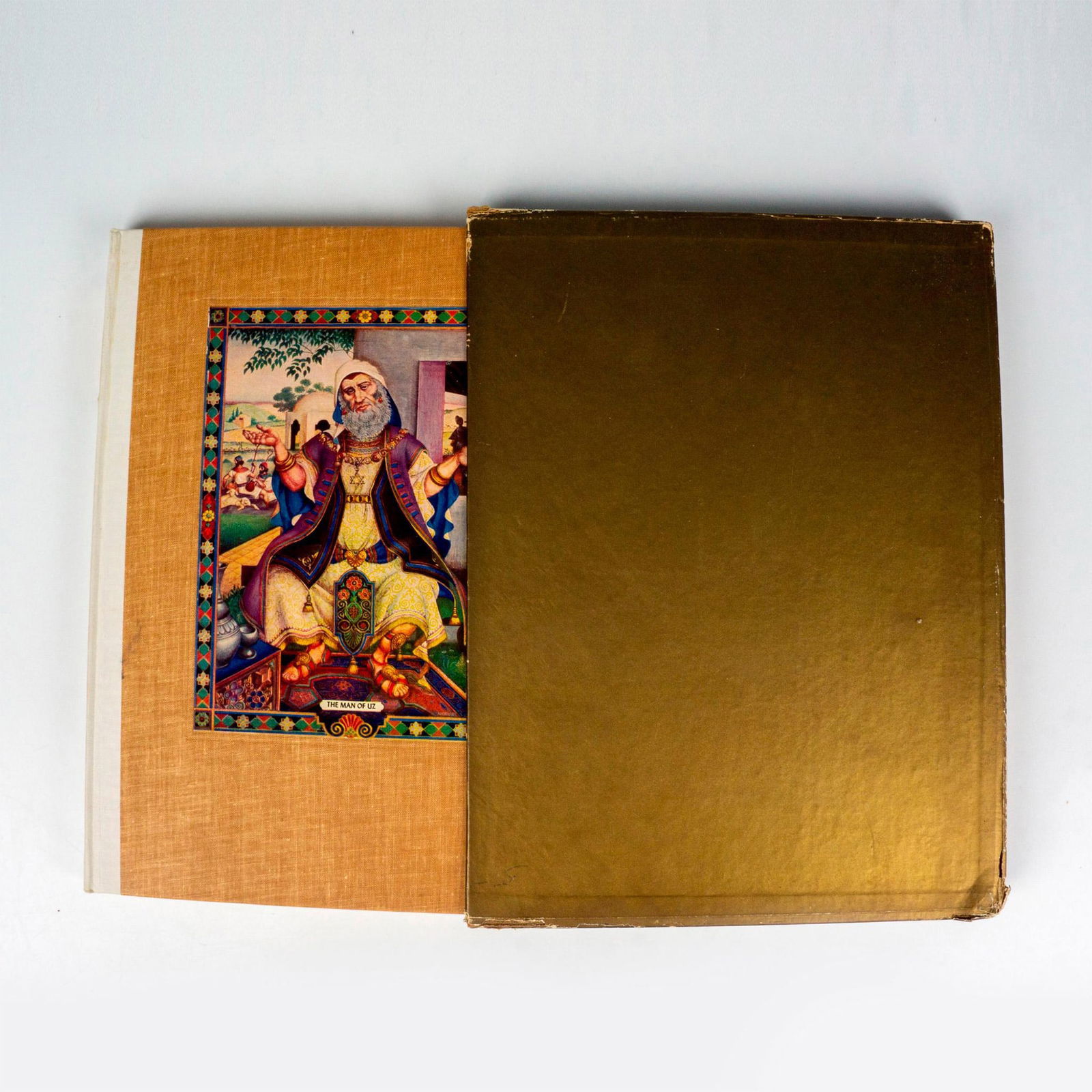 The Book of Job, Translated by Arthur Szyk: New York: The Heritage Press, 1946. Tawny-brown hardcover book with a colored illustration of The Man of Uz by Arthur Szyk. Includes its original box sleeve. 148-pages with scripture from the Book of