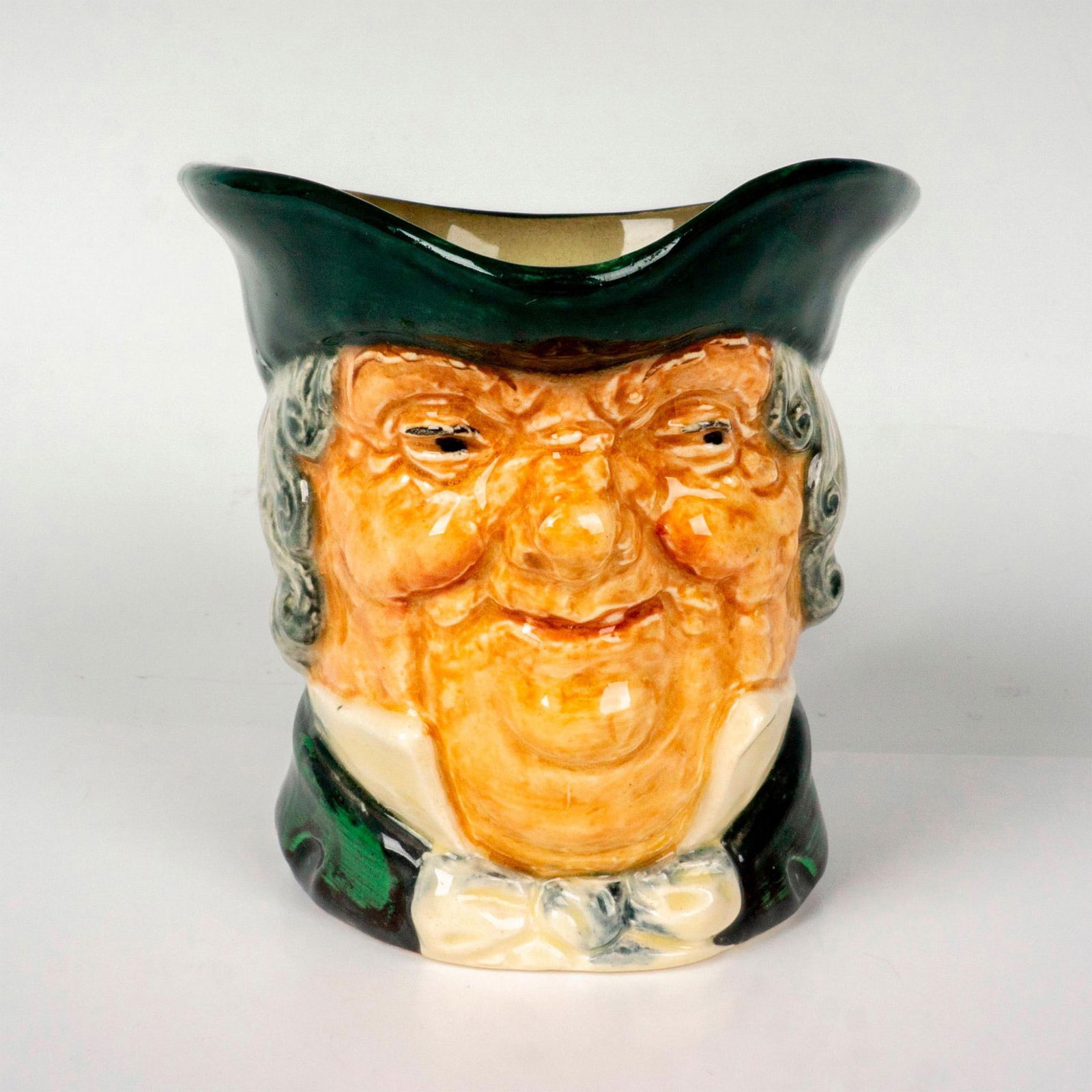 Royal Doulton Small Character Jug, Parson Brown D5529: Souvenir From Bentalls Jubilee Year backstamp. Hand painted in green, and grey coloration. Royal Doulton backstamp. Artist: Charles Noke Issued: 1935-1960 Dimensions: 2.75"L x 4"W x 3.25"H Manufacture